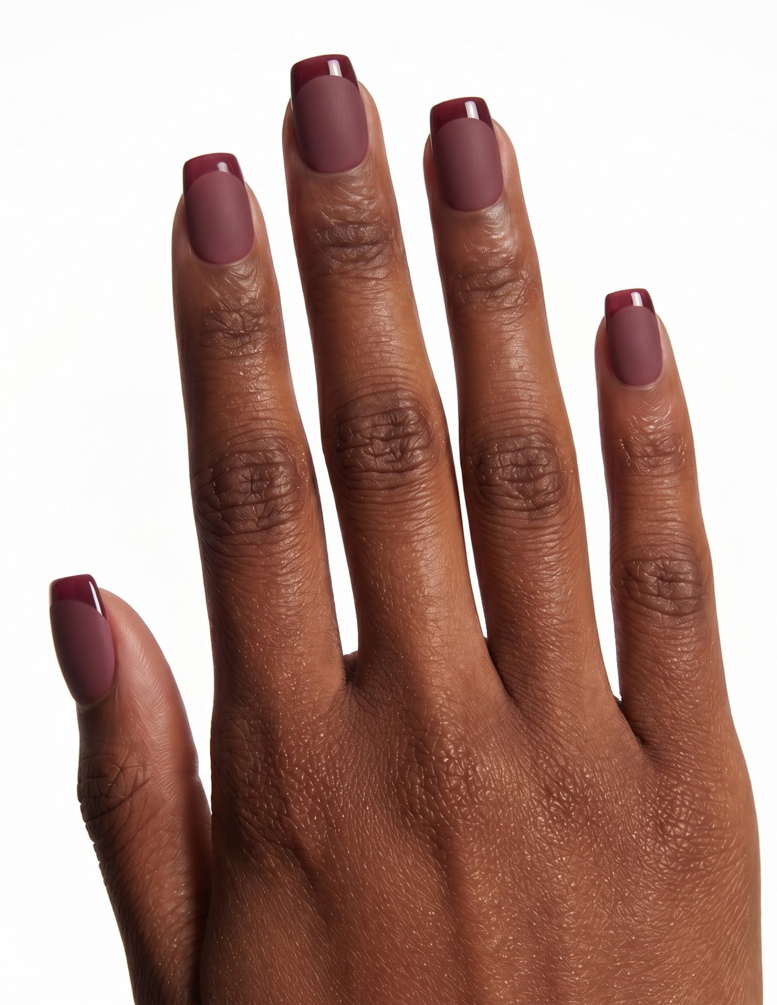Bordeaux press-on nails — Coffin (short), deep-skin hand, back of hand