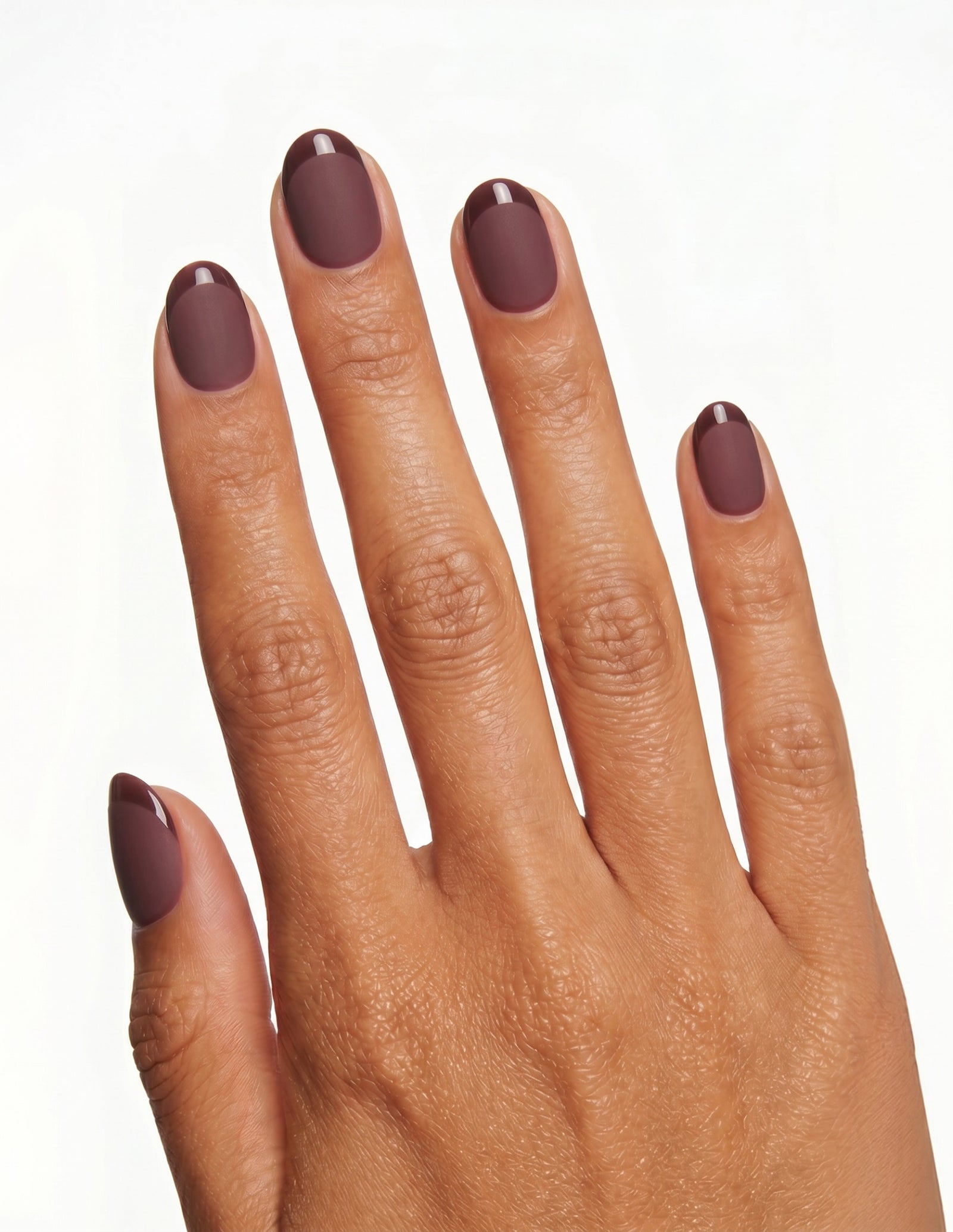 Bordeaux press-on nails — Oval (extra-short), tan hand, back of hand