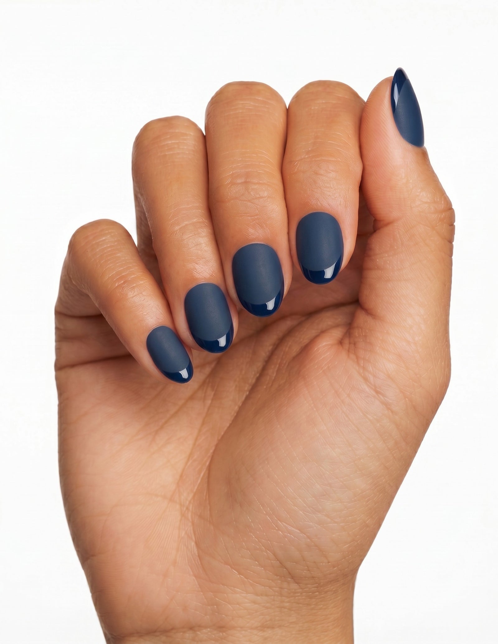 Midnight press-on nails — Oval (extra-short), tan hand, fingers curled