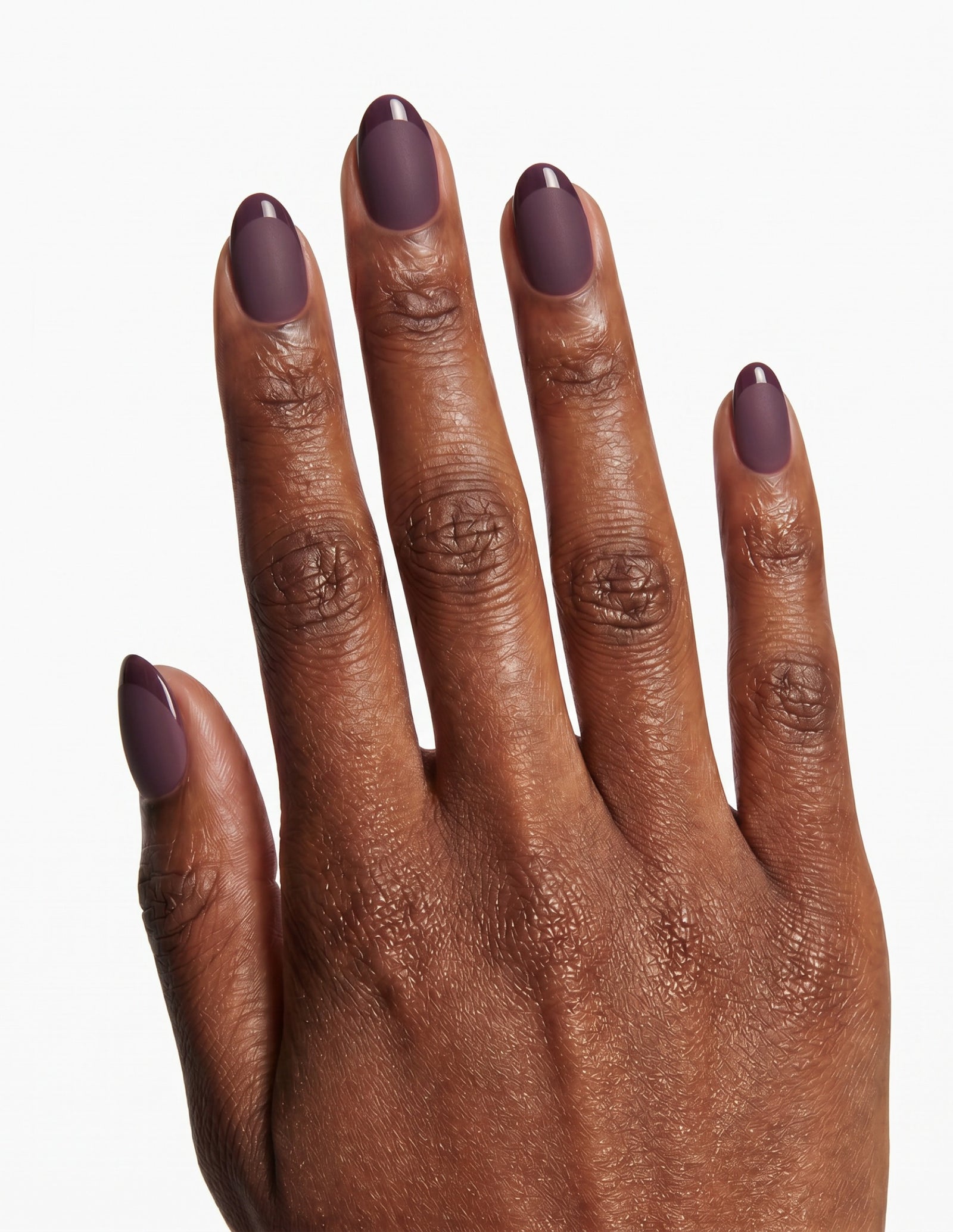 Aubergine press-on nails — Almond (extra-short), deep-skin hand, back of hand