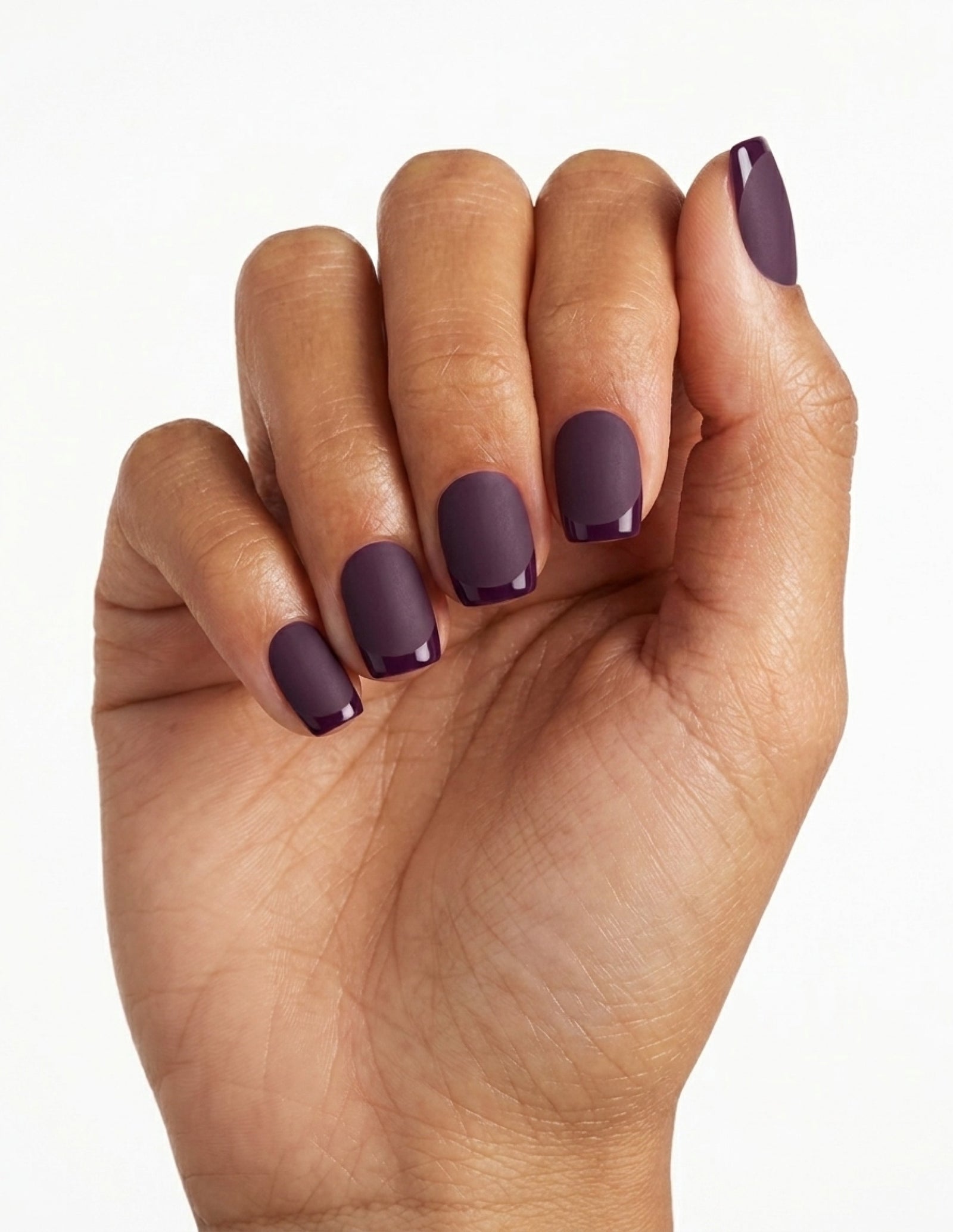 Aubergine press-on nails — Coffin (short), tan hand, fingers curled
