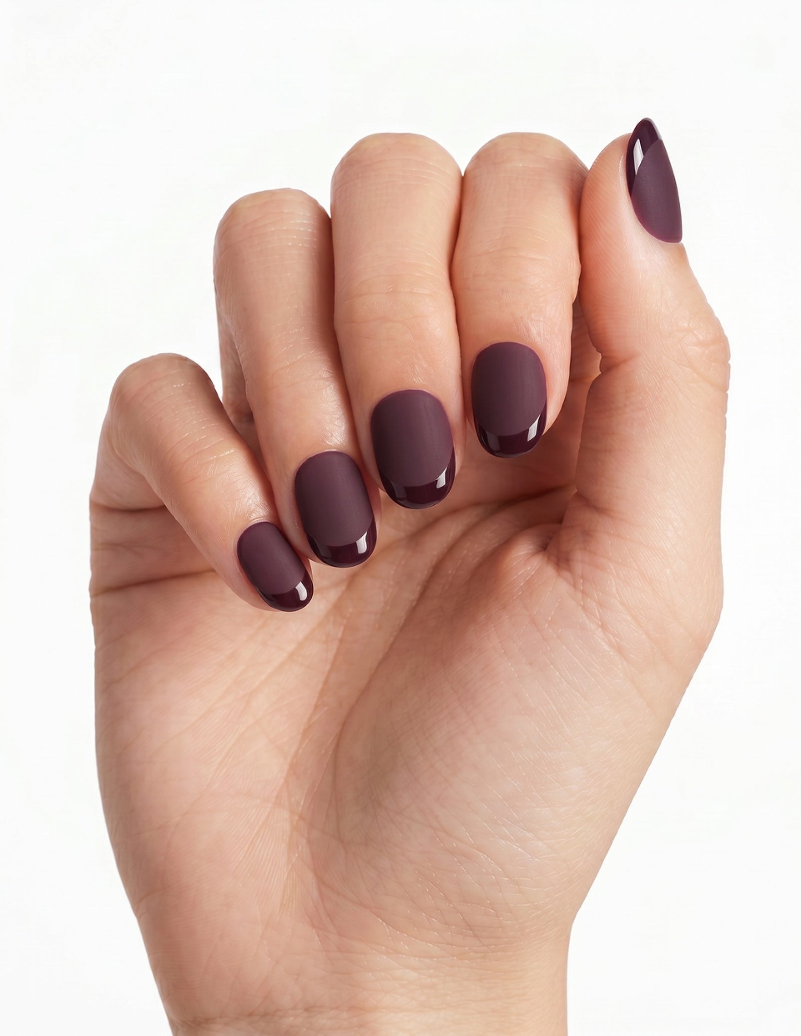 Aubergine press-on nails — Oval (extra-short), light-skin hand, fingers curled