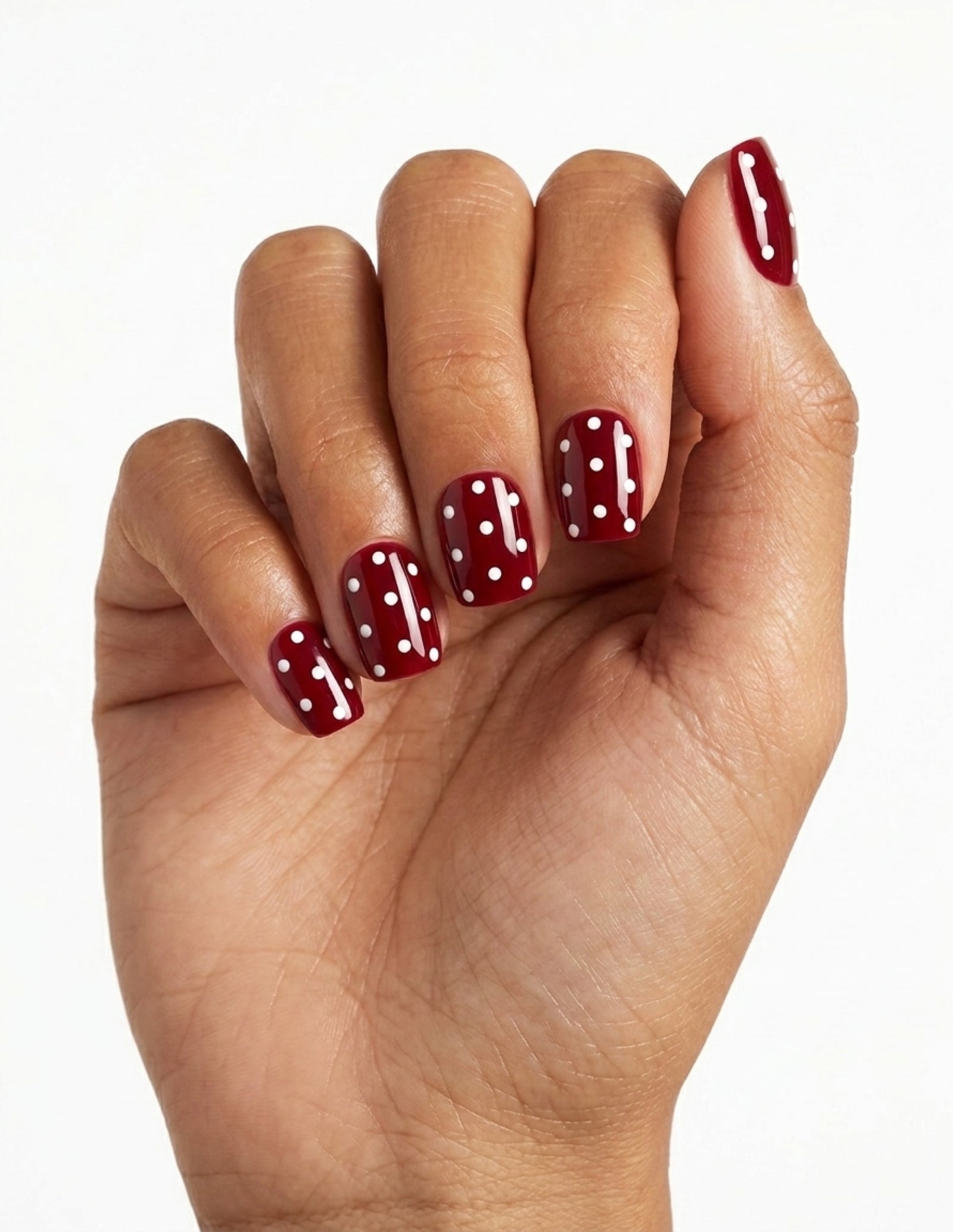 Strawberry press-on nails — Coffin (short), tan hand, fingers curled