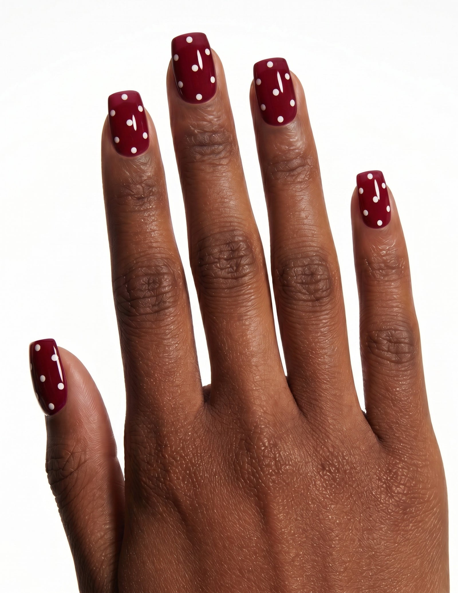 Strawberry press-on nails — Coffin (short), deep-skin hand, back of hand