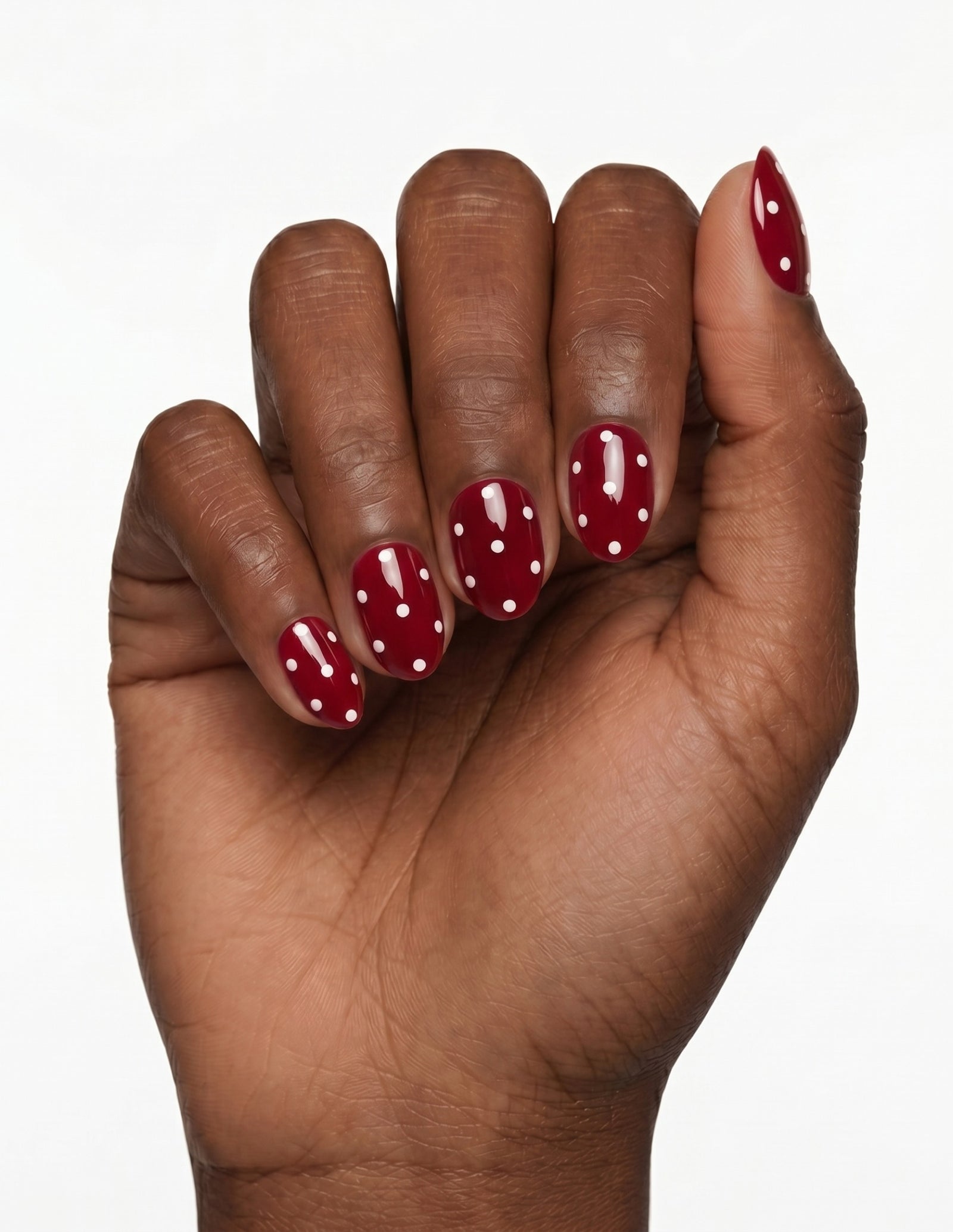 Strawberry press-on nails — Oval (extra-short), deep-skin hand, fingers curled