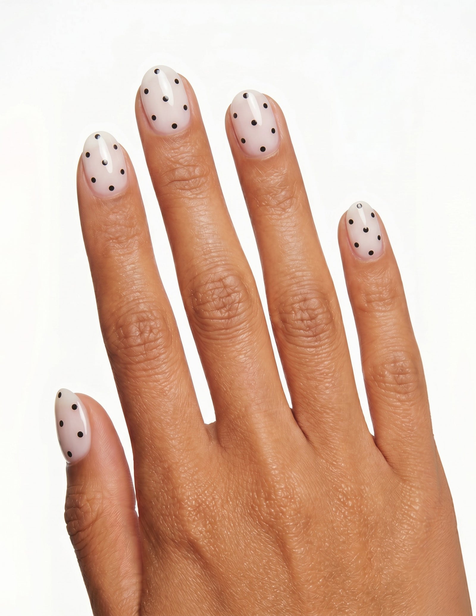 Domino press-on nails — Oval (extra-short), tan hand, back of hand