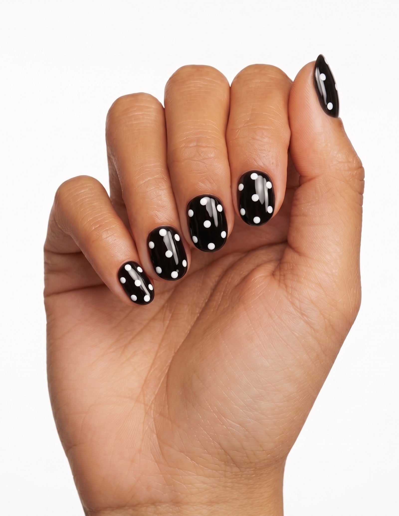 Dice press-on nails — Oval (extra-short), tan hand, fingers curled