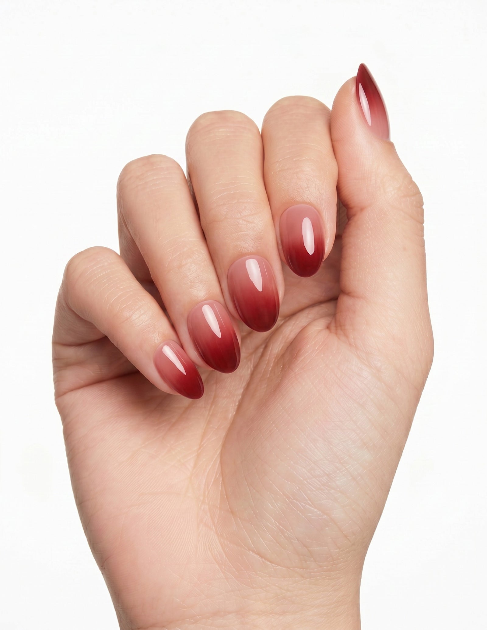 Cherry Cola press-on nails — Almond (extra-short), light-skin hand, fingers curled