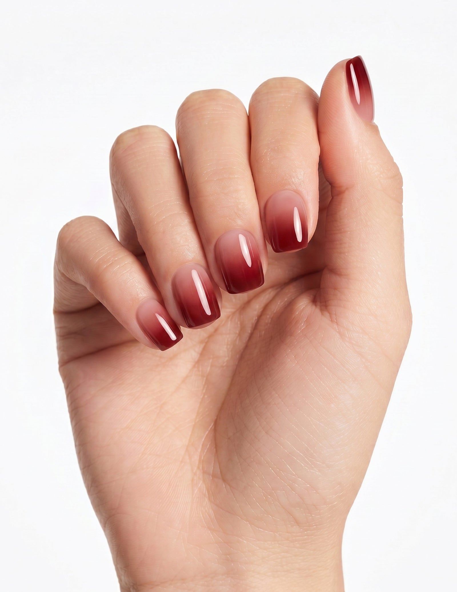 Cherry Cola press-on nails — Coffin (short), light-skin hand, fingers curled