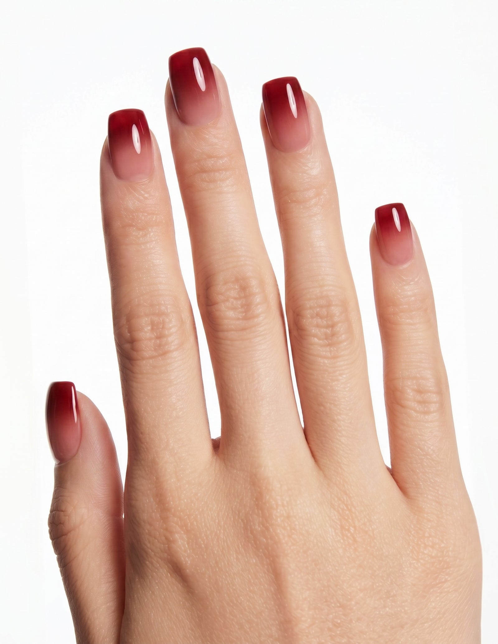 Cherry Cola press-on nails — Coffin (short), tan hand, fingers curled