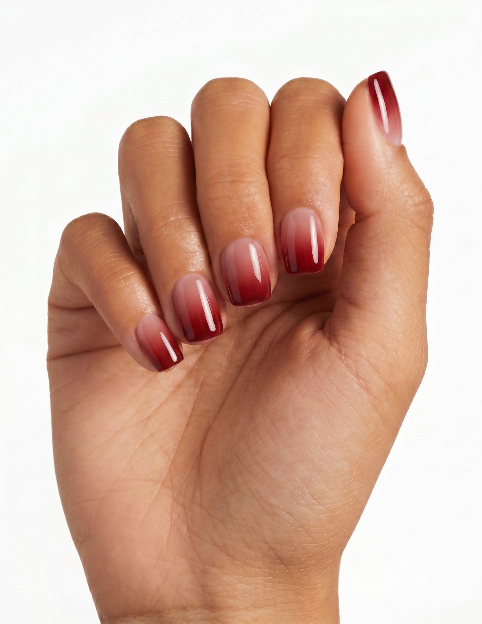 Cherry Cola press-on nails — Coffin (short), deep-skin hand, back of hand