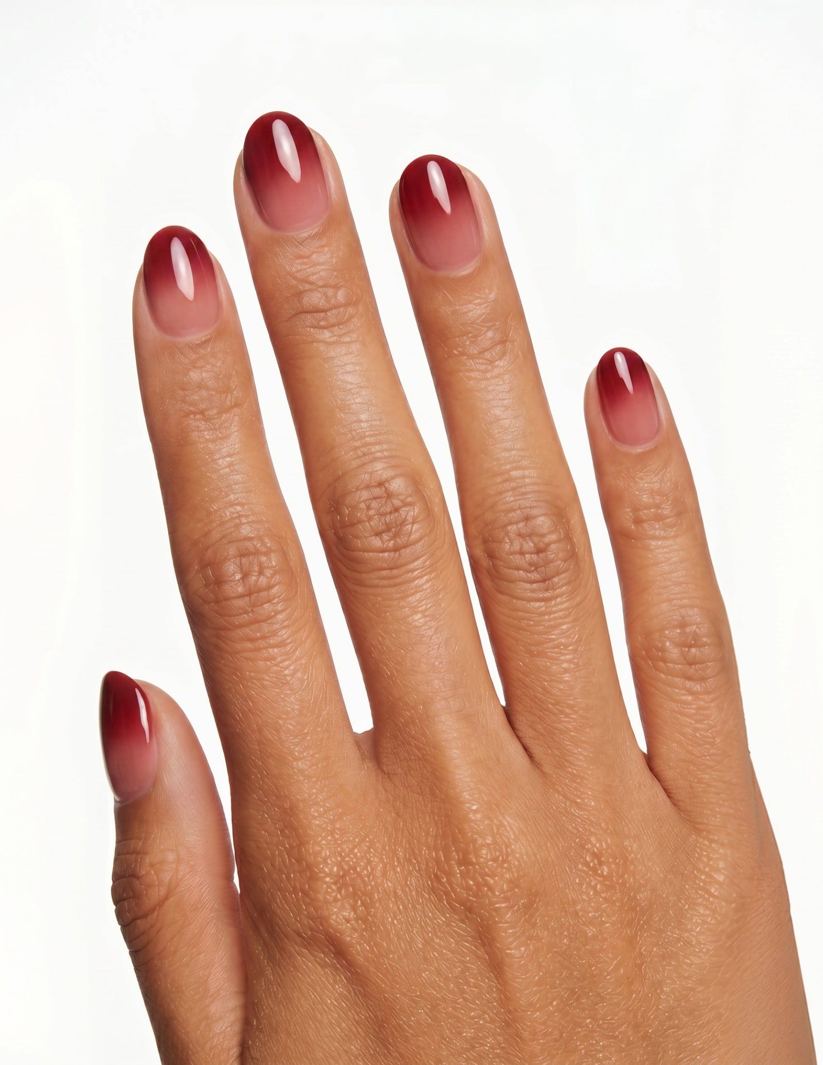 Cherry Cola press-on nails — Oval (extra-short), tan hand, back of hand