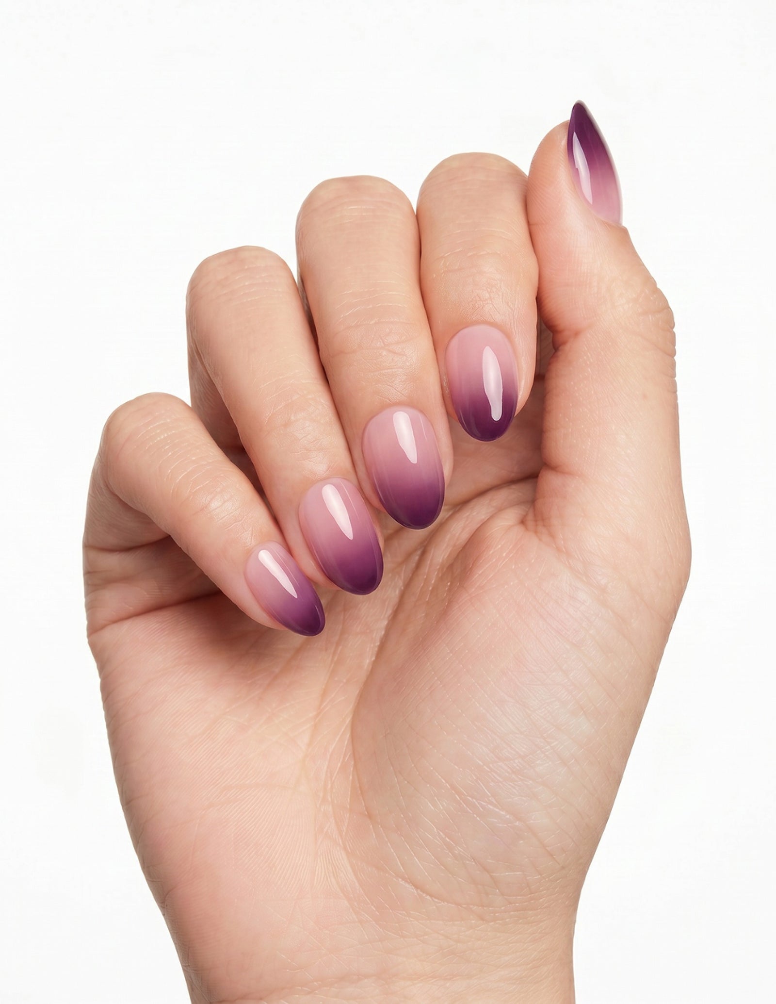 Plum Fade press-on nails — Almond (extra-short), light-skin hand, fingers curled