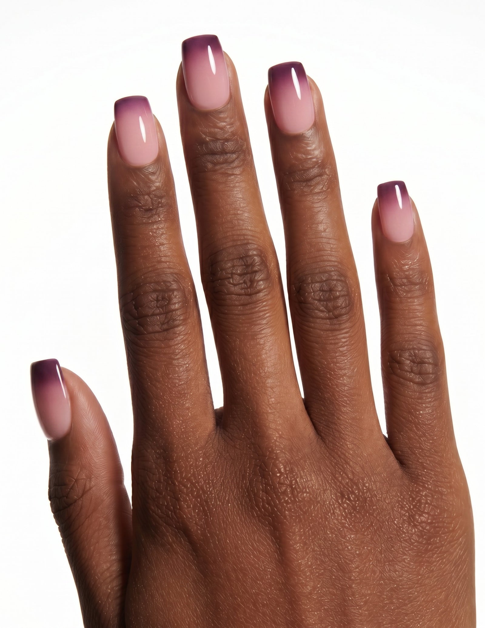 Plum Fade press-on nails — Coffin (short), deep-skin hand, back of hand