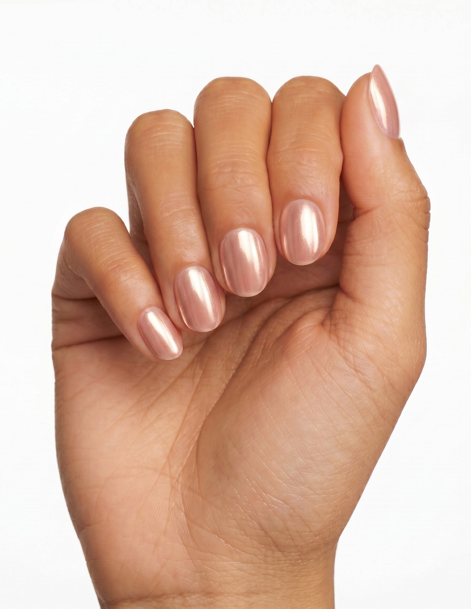 Rose Chrome press-on nails — Oval (extra-short), deep-skin hand, fingers curled