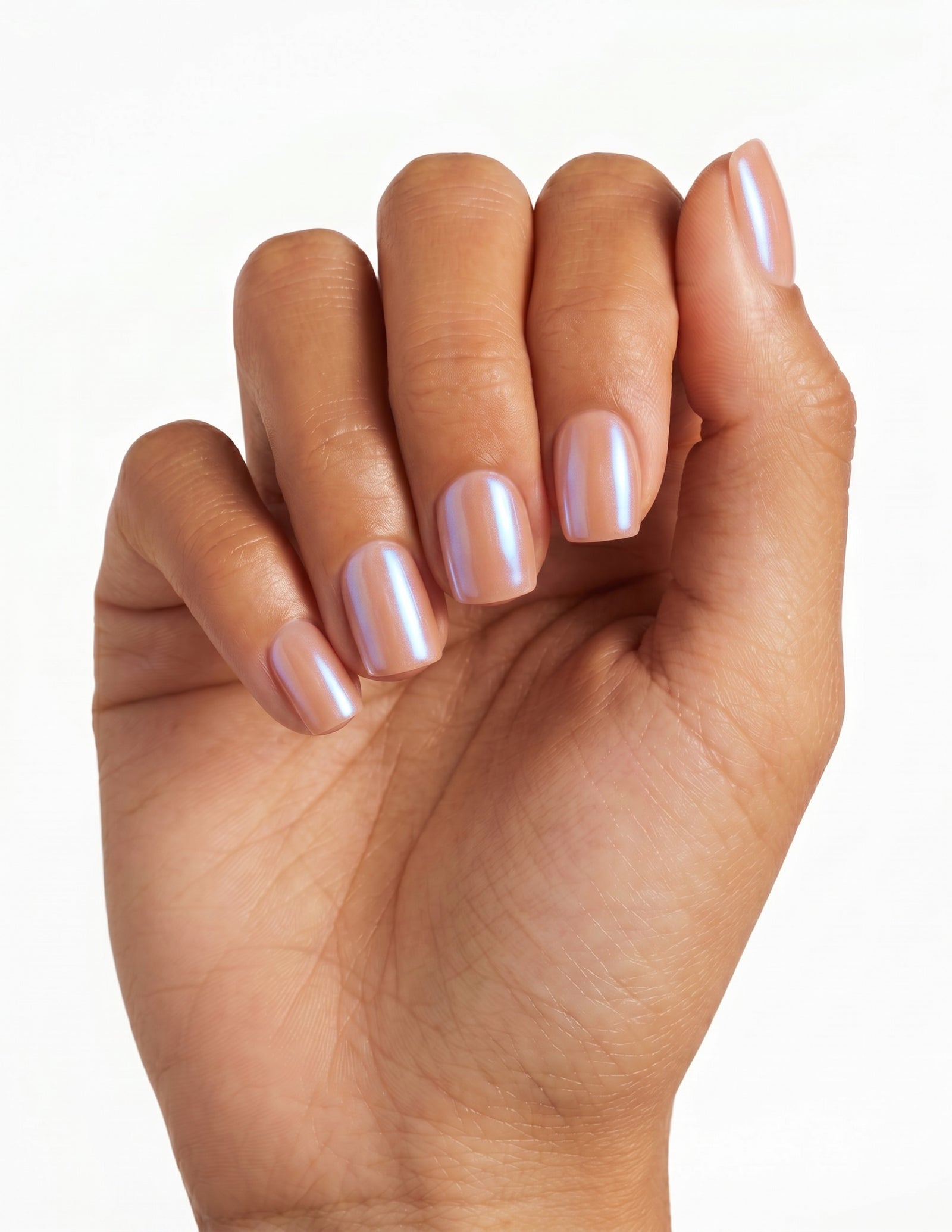 Peach Fuzz press-on nails — Coffin (short), tan hand, fingers curled