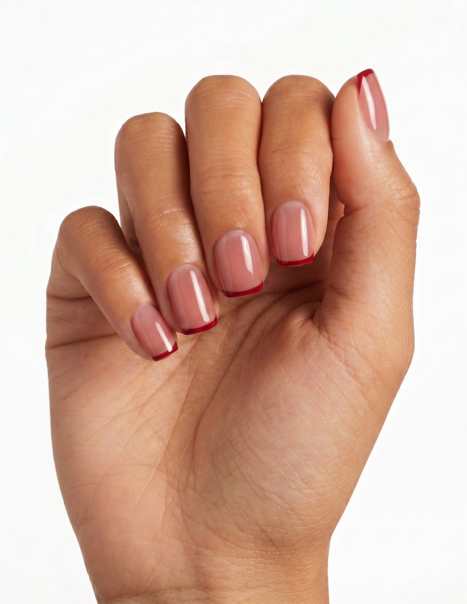 Cherry French press-on nails — Coffin (short), tan hand, fingers curled