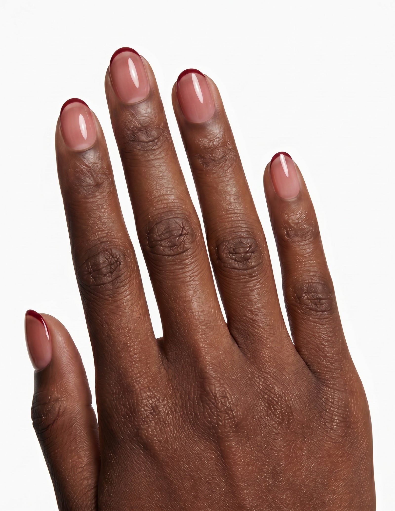 Cherry French press-on nails — Oval (extra-short), deep-skin hand, back of hand