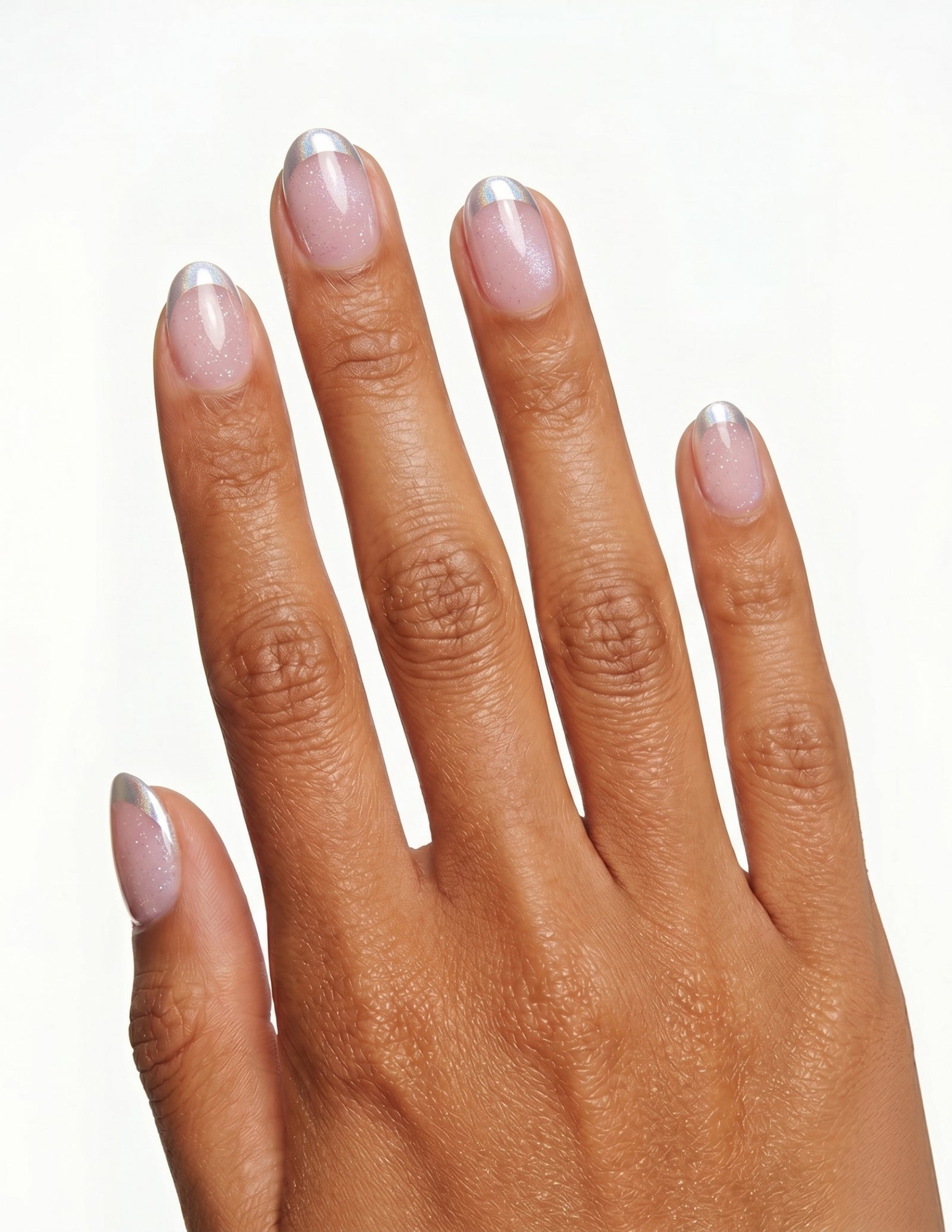 Sugar Tips press-on nails — Oval (extra-short), tan hand, back of hand