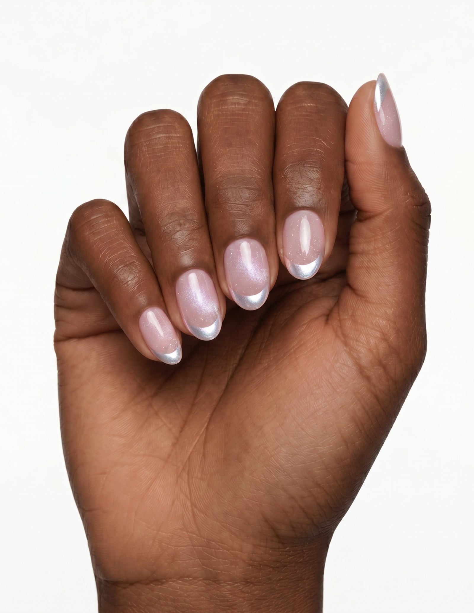 Sugar Tips press-on nails — Oval (extra-short), deep-skin hand, fingers curled
