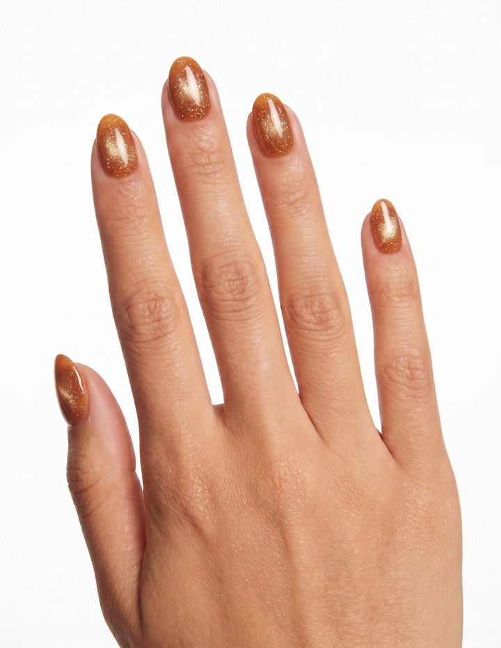 Cinnamon Velvet press-on nails — Almond (extra-short), tan hand, back of hand