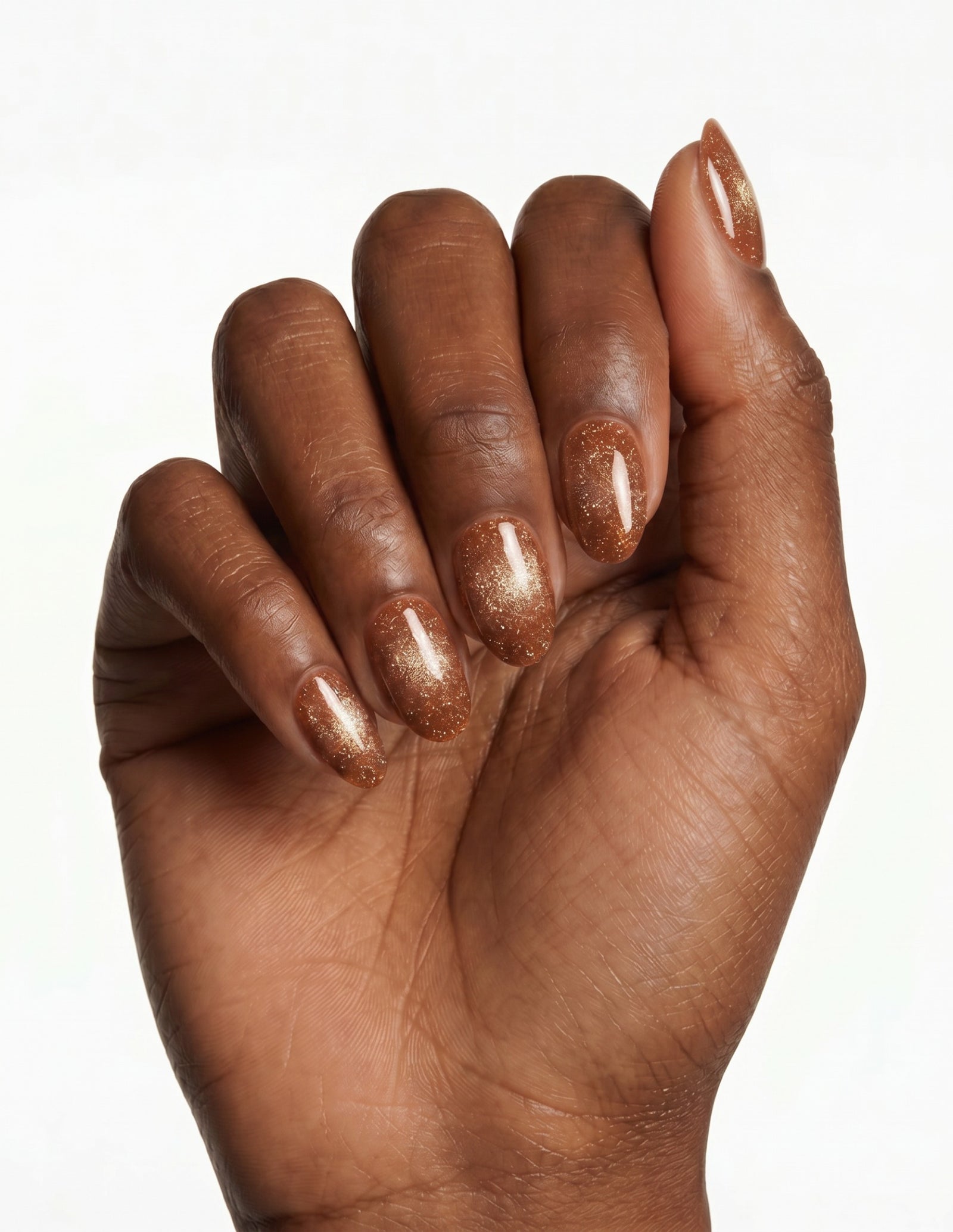 Cinnamon Velvet press-on nails — Almond (extra-short), deep-skin hand, fingers curled