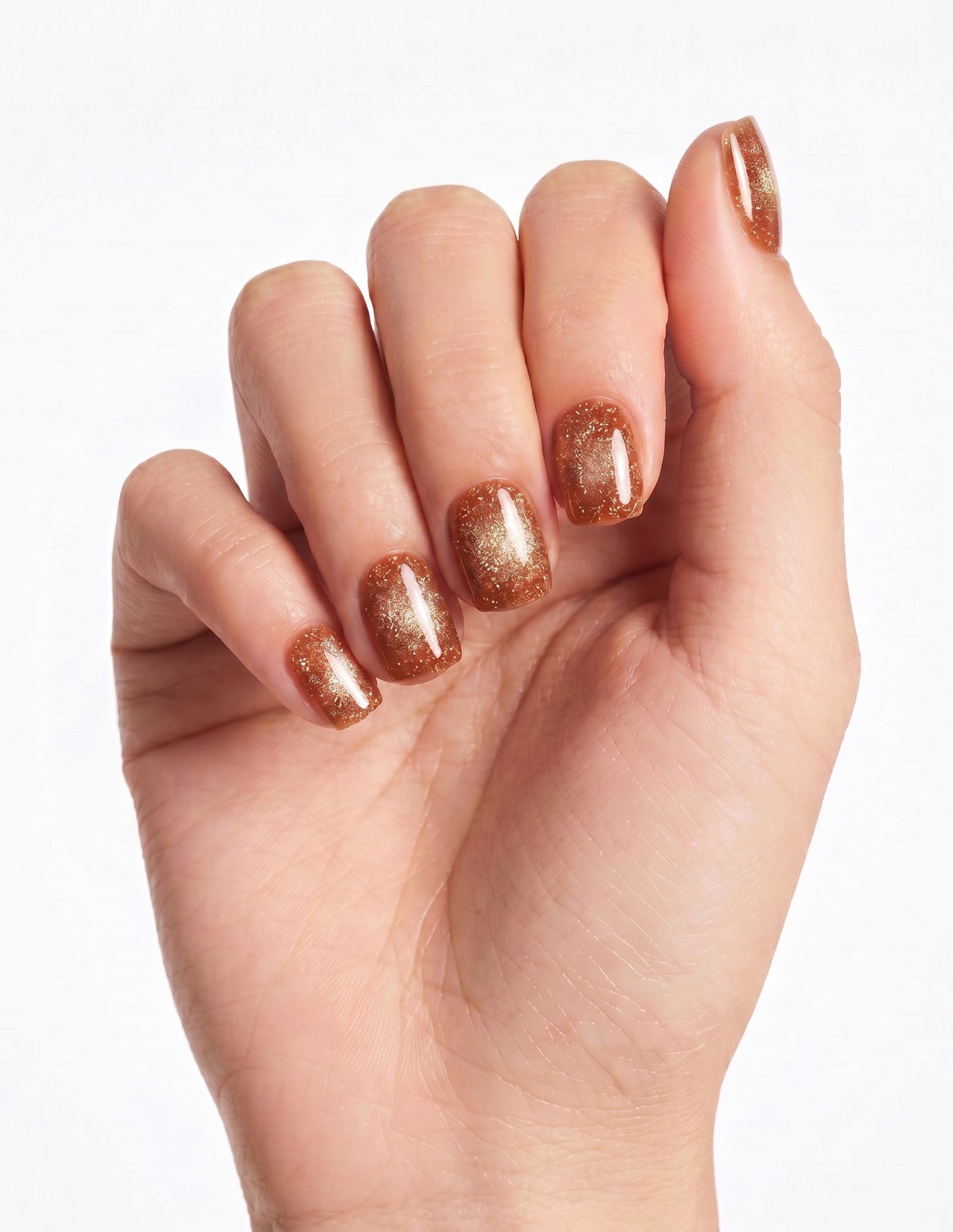 Cinnamon Velvet press-on nails — Coffin (short), light-skin hand, fingers curled