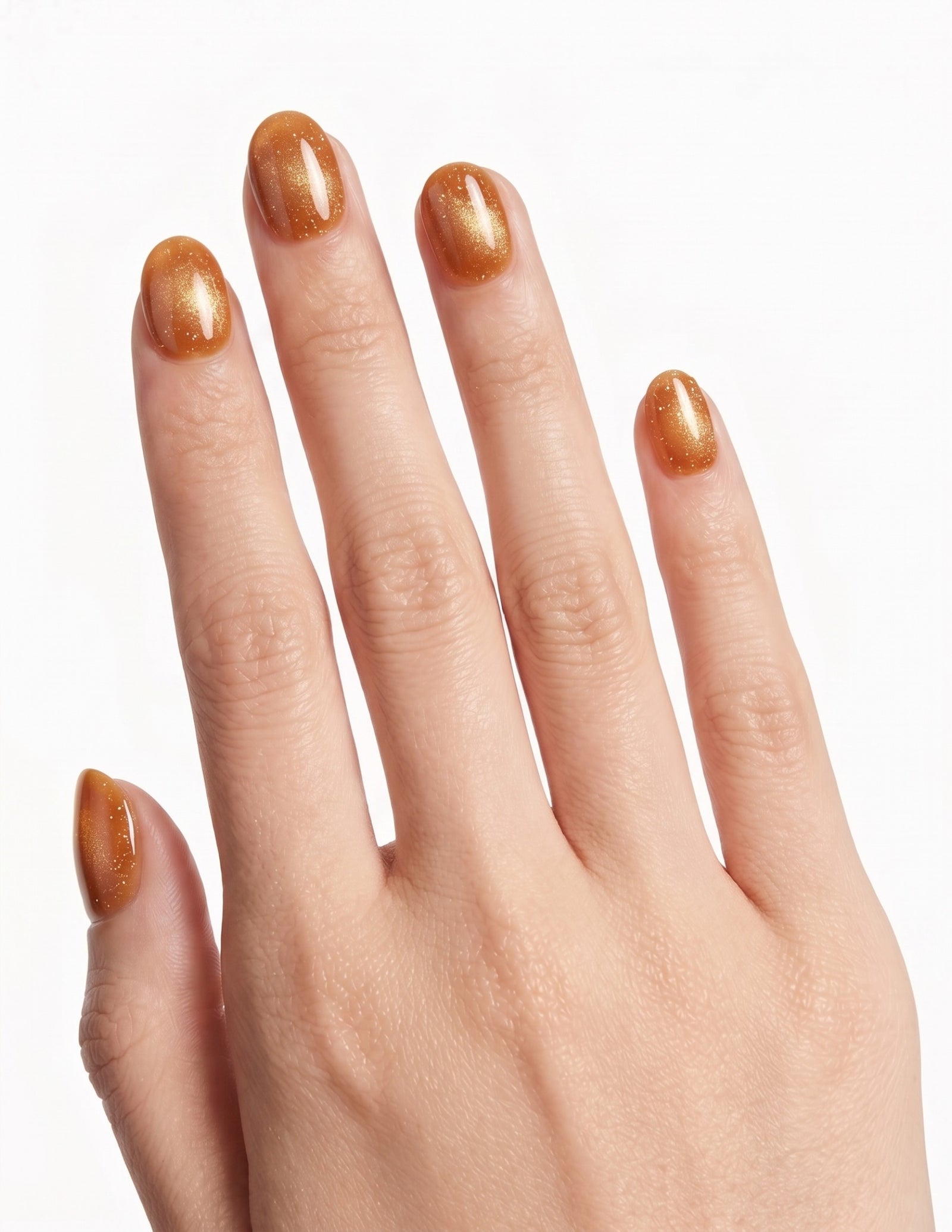 Cinnamon Velvet press-on nails — Oval (extra-short), tan hand, back of hand