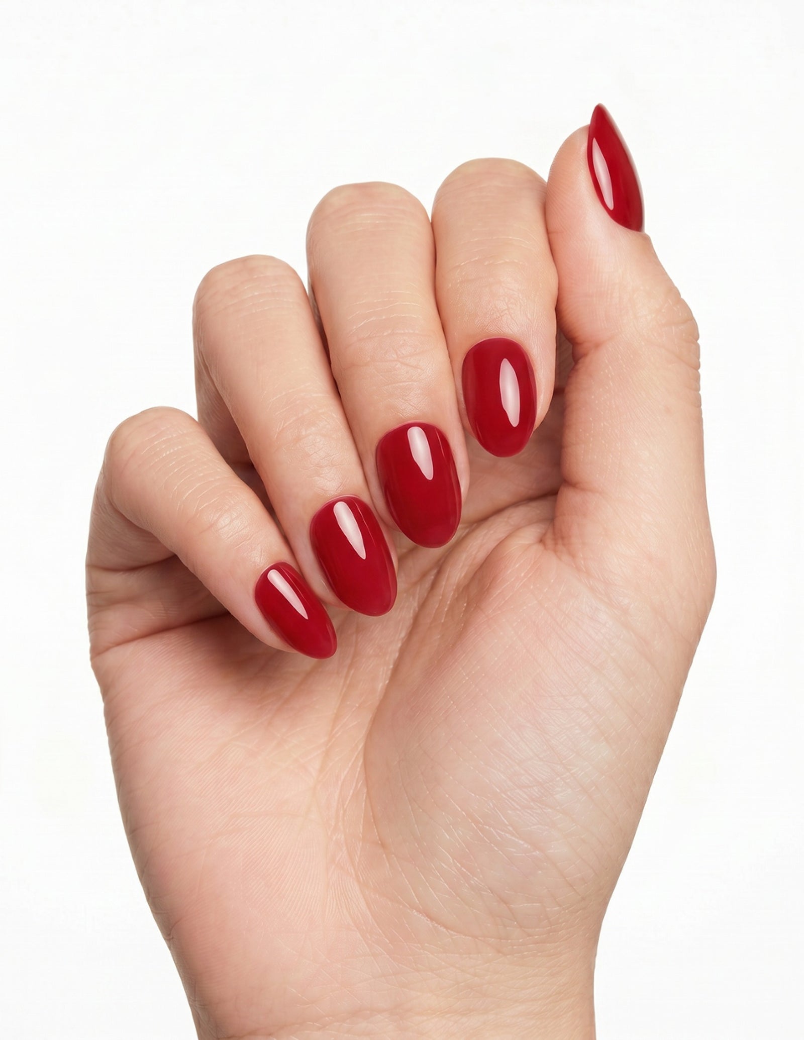 The Red press-on nails — Almond (extra-short), light-skin hand, fingers curled