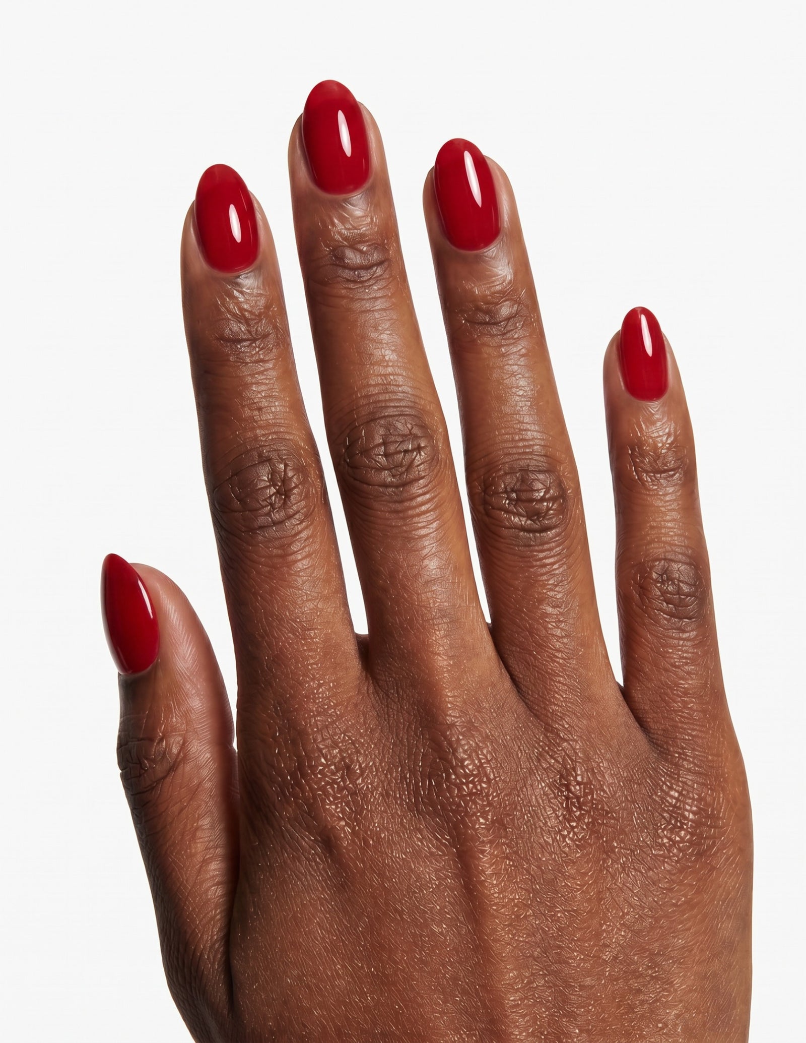 The Red press-on nails — Almond (extra-short), deep-skin hand, back of hand