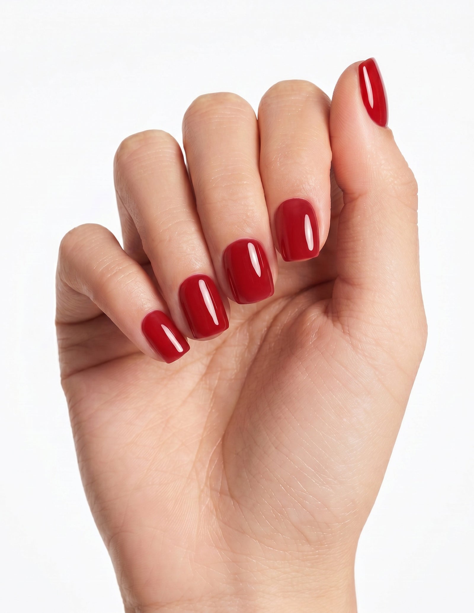 The Red press-on nails — Coffin (short), light-skin hand, fingers curled