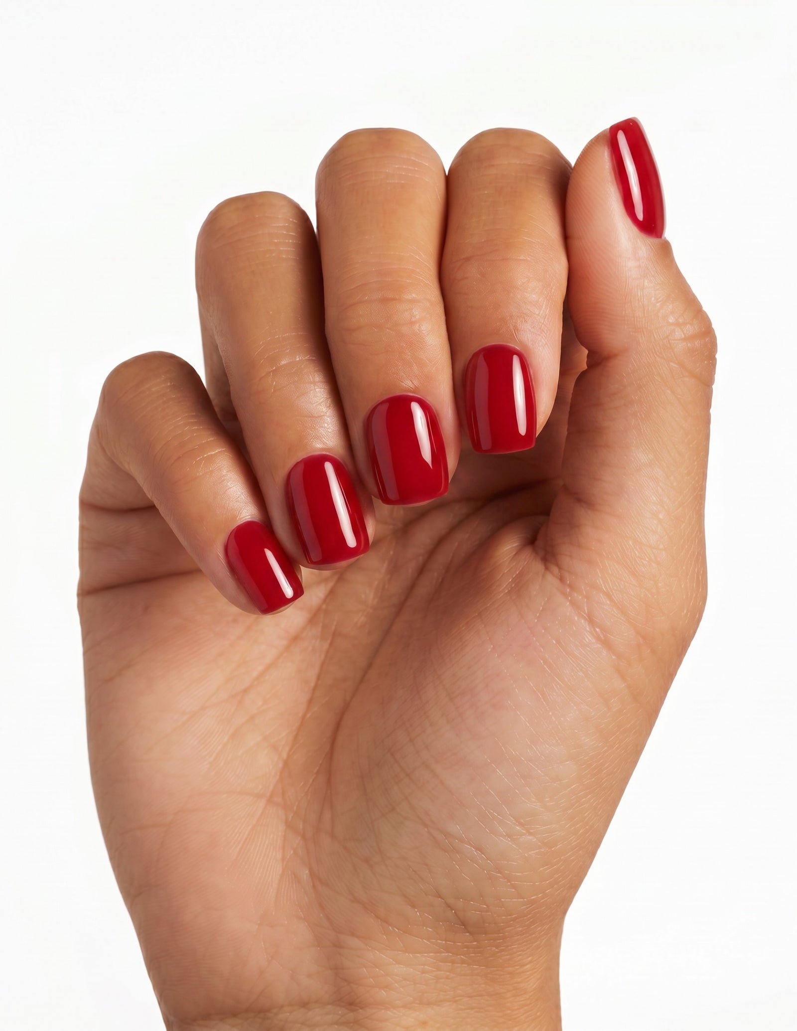 The Red press-on nails — Coffin (short), tan hand, fingers curled
