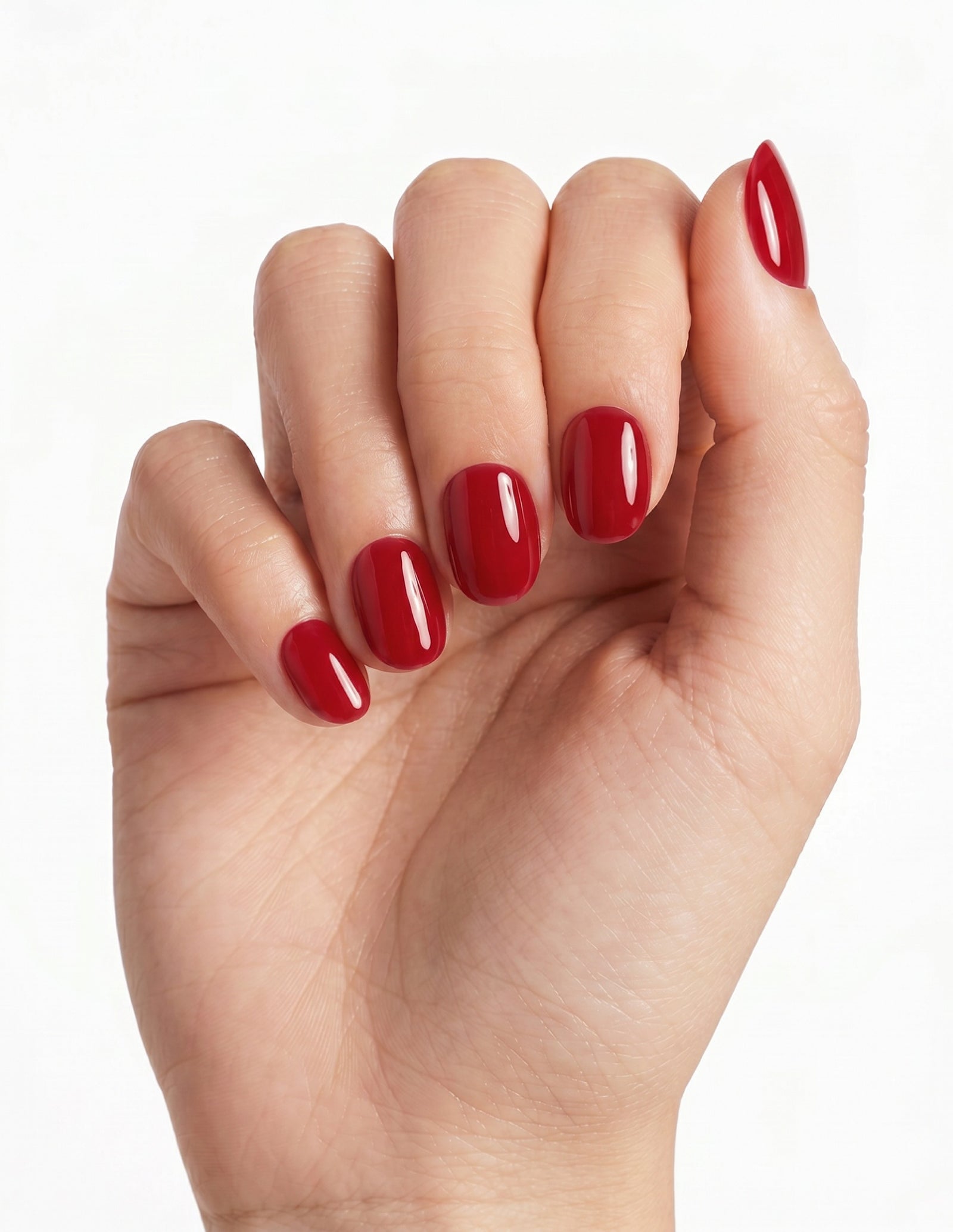 The Red press-on nails — Oval (extra-short), light-skin hand, fingers curled