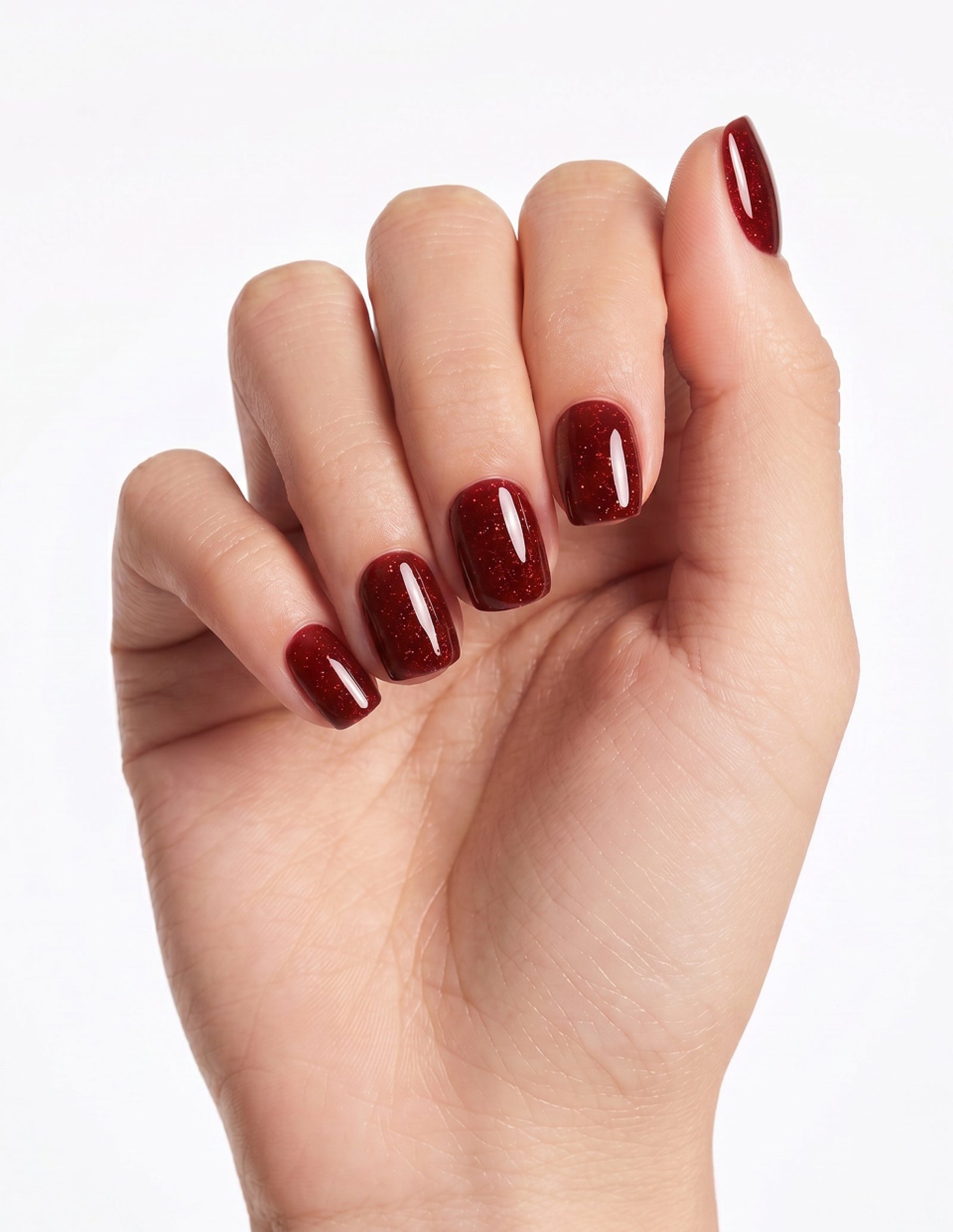 Garnet press-on nails — Coffin (short), light-skin hand, fingers curled