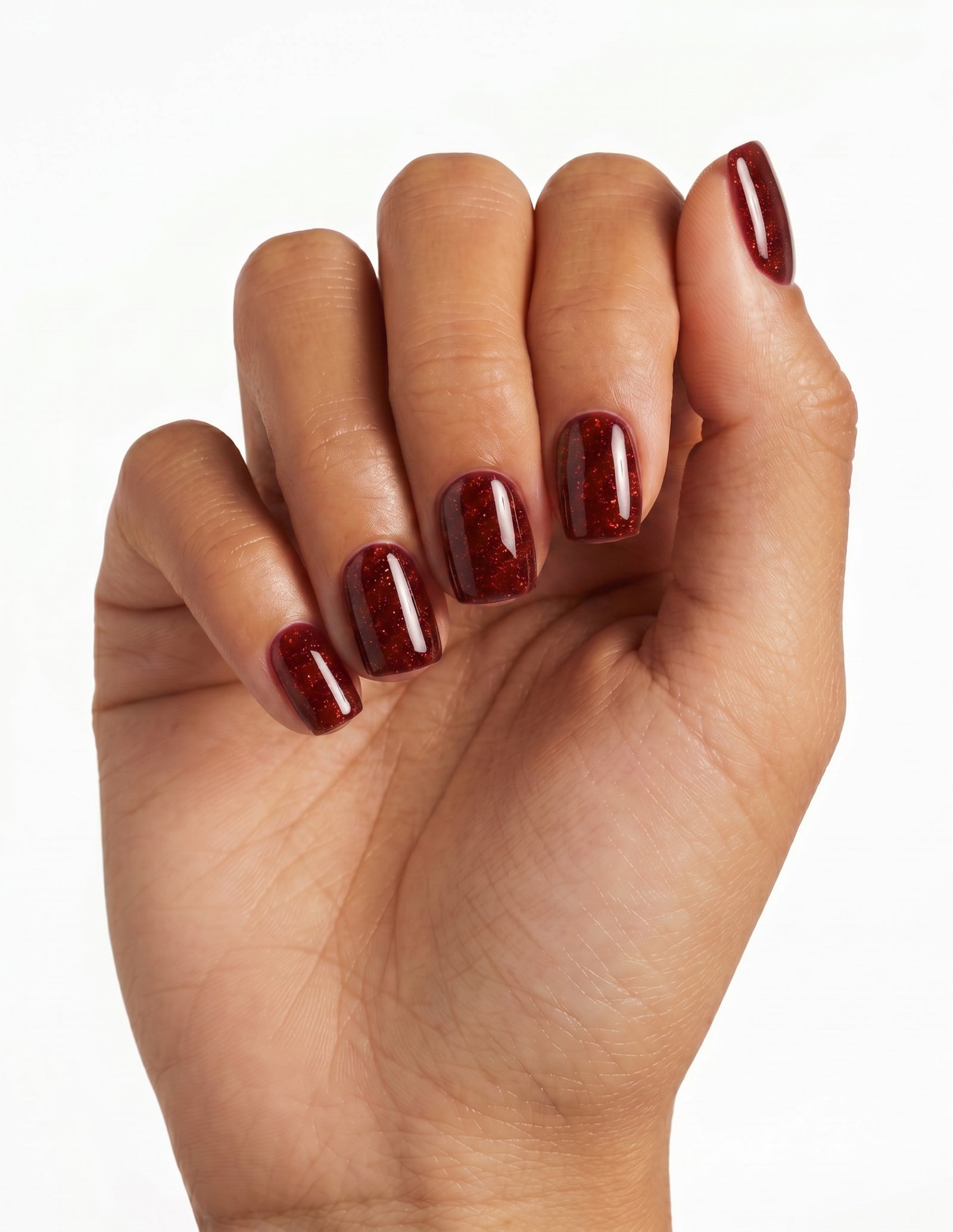 Garnet press-on nails — Coffin (short), tan hand, fingers curled