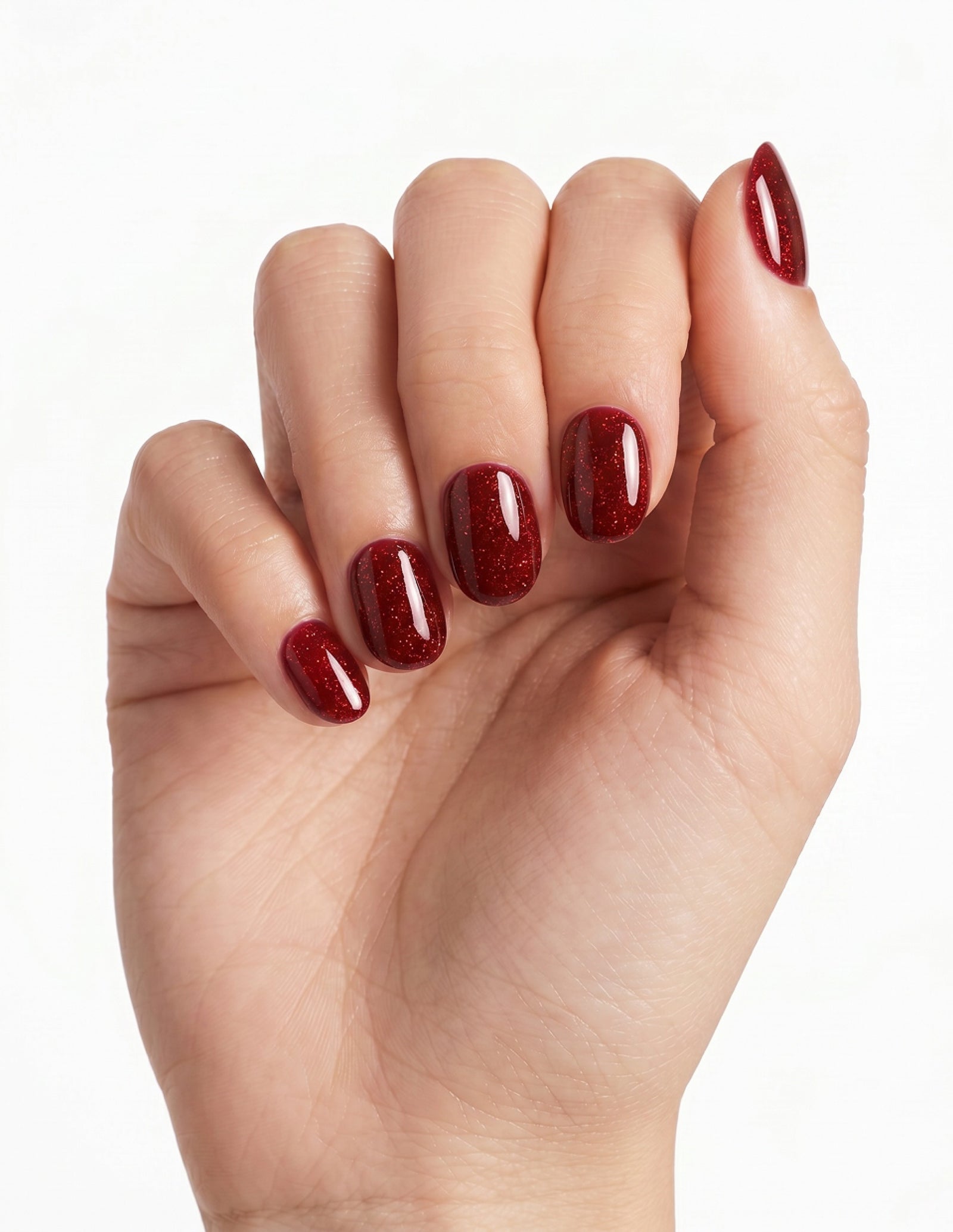 Garnet press-on nails — Oval (extra-short), light-skin hand, fingers curled