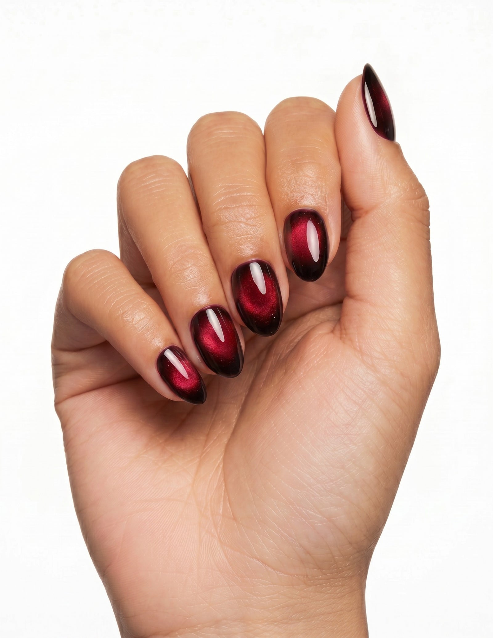 Cherry Noir press-on nails — Almond (extra-short), tan hand, fingers curled