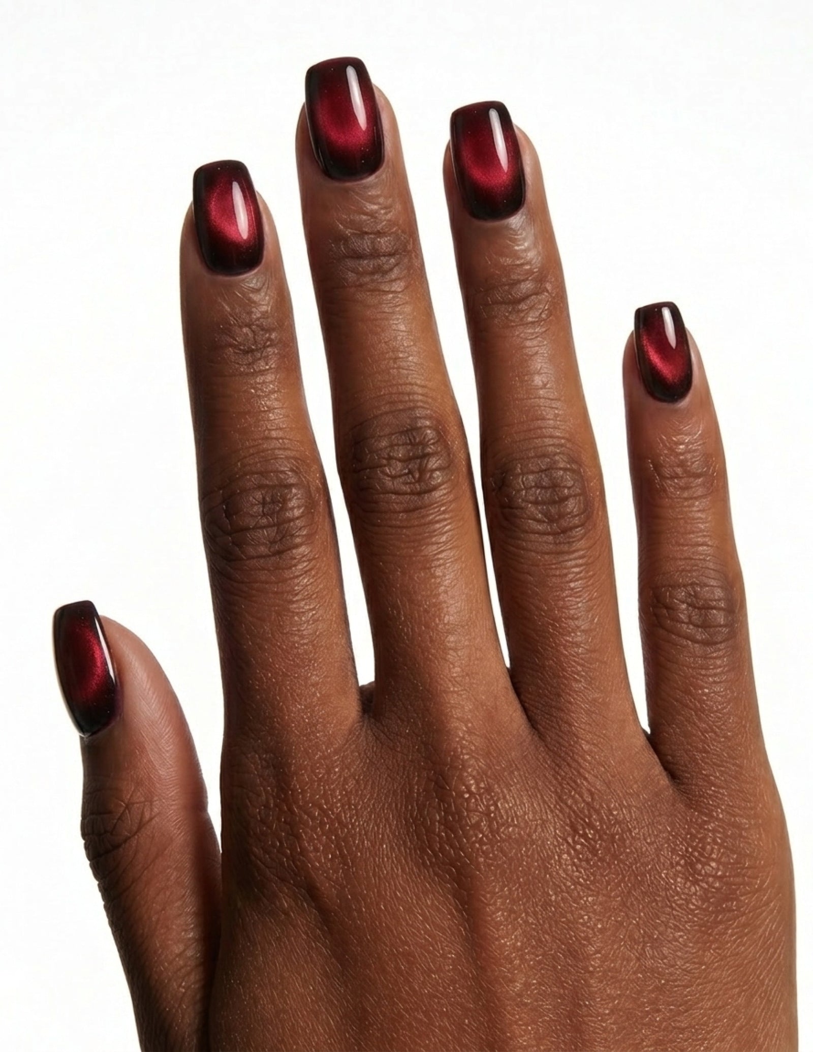 Cherry Noir press-on nails — Coffin (short), deep-skin hand, back of hand
