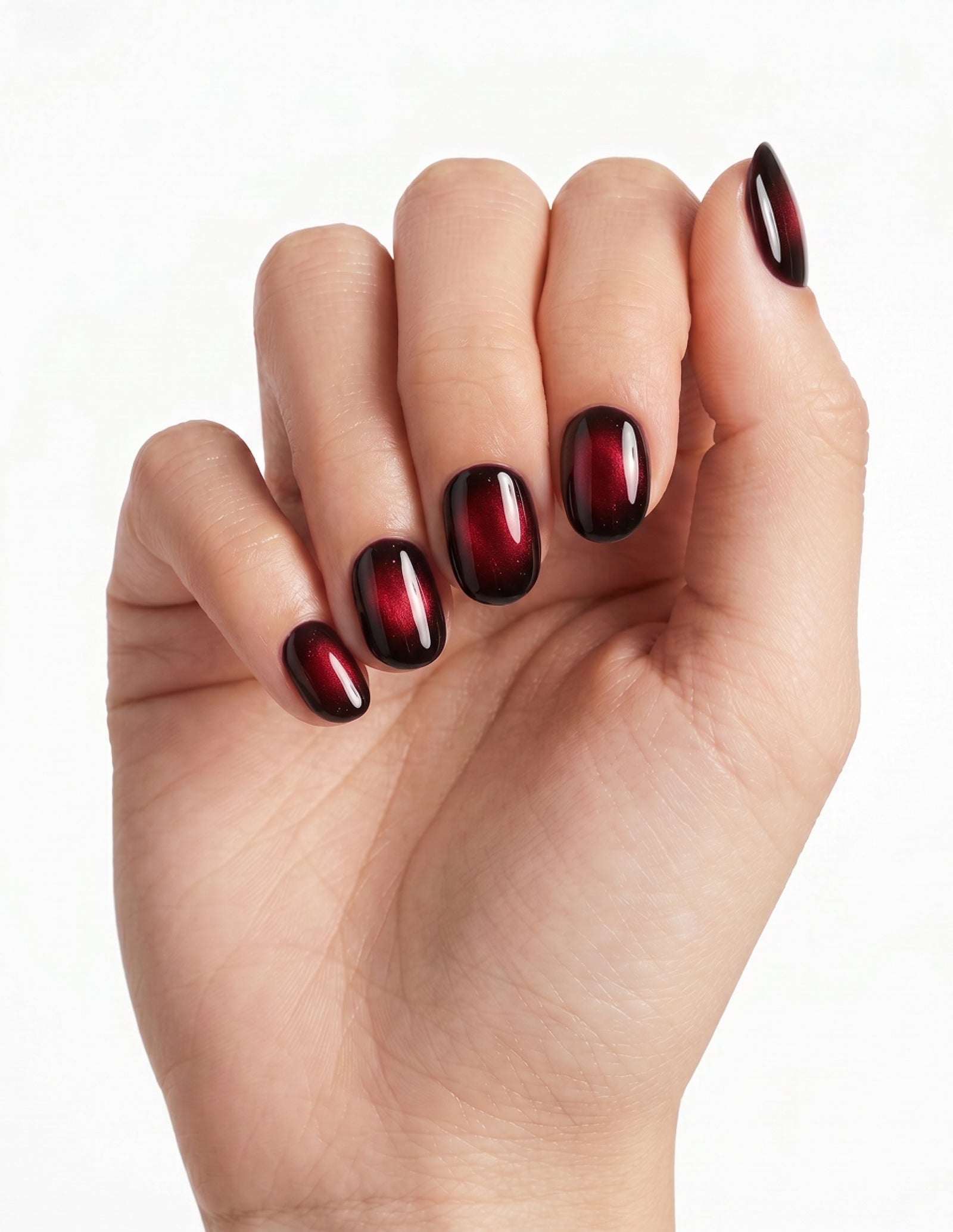 Cherry Noir press-on nails — Oval (extra-short), light-skin hand, fingers curled