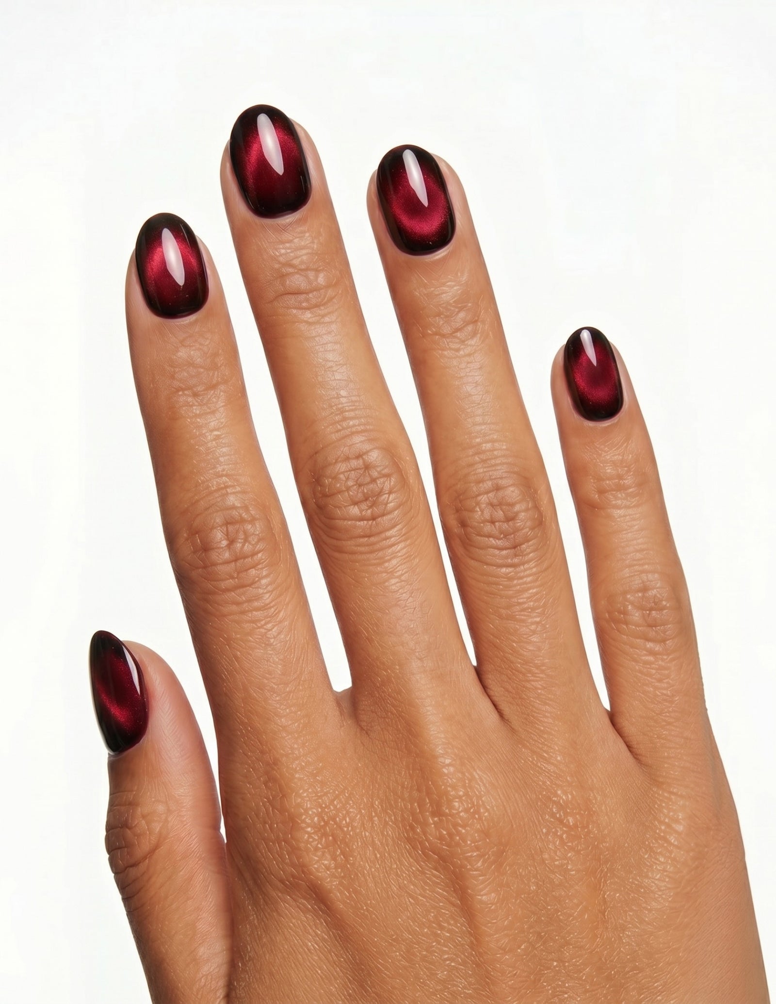 Cherry Noir press-on nails — Oval (extra-short), tan hand, back of hand