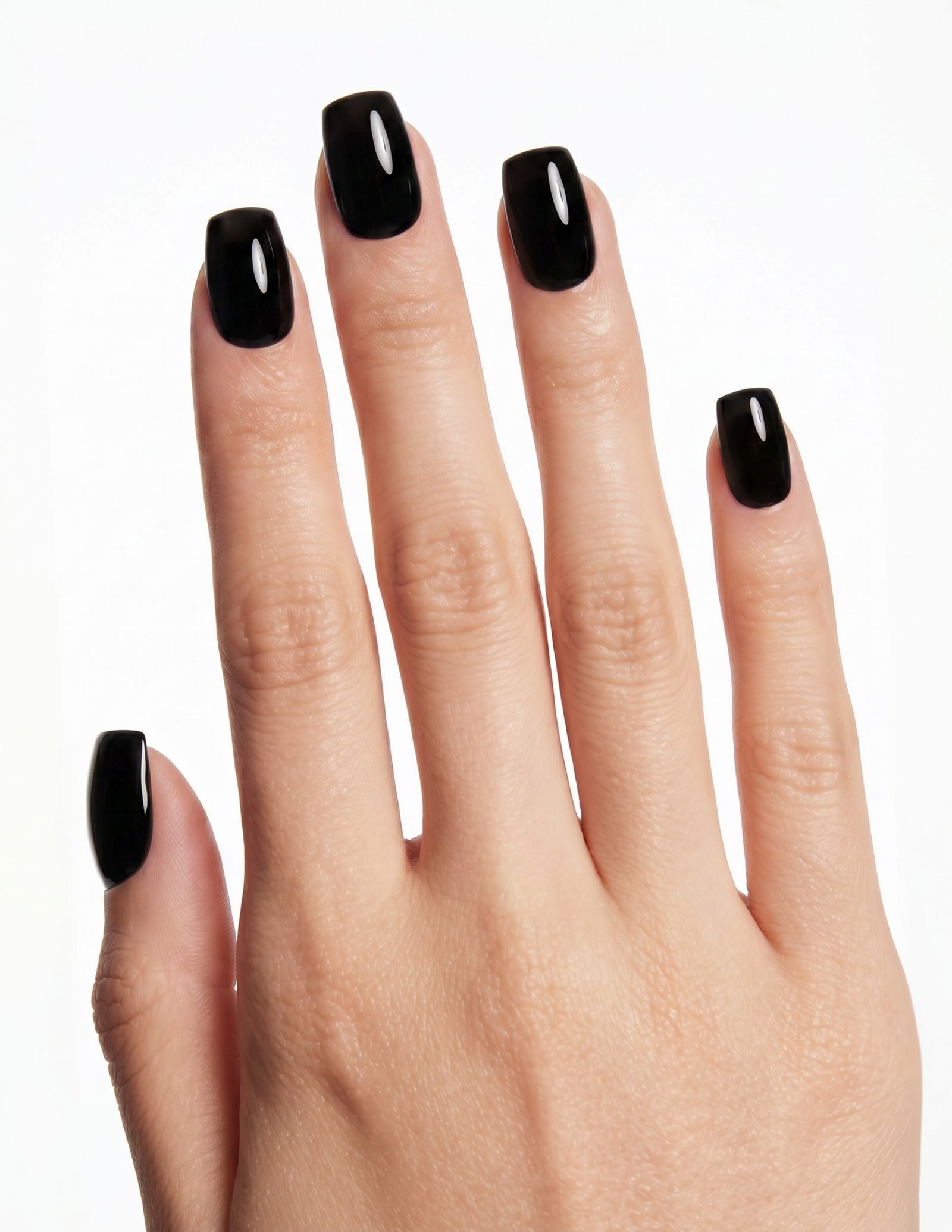 Blackout press-on nails — Coffin (short), light-skin hand, back of hand