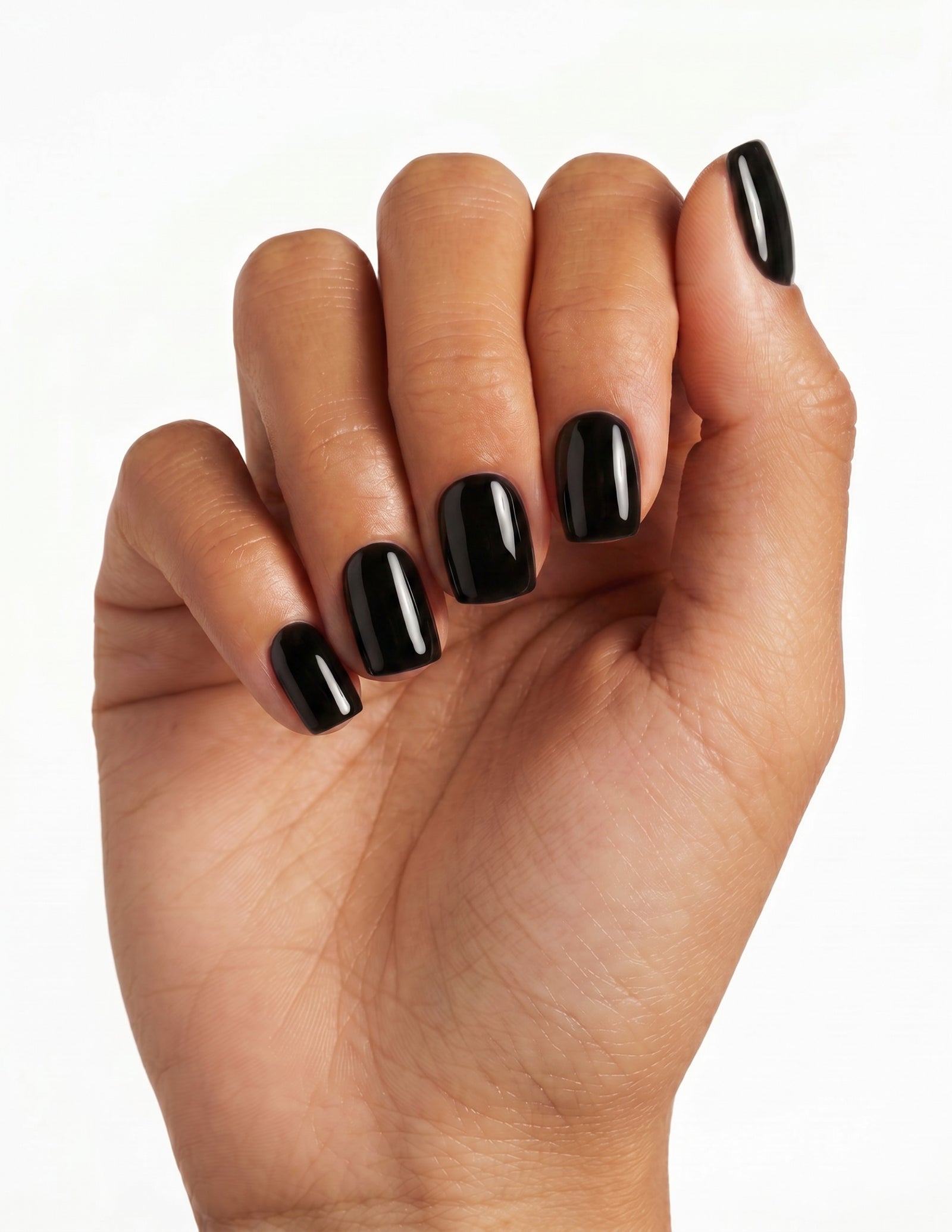 Blackout press-on nails — Coffin (short), tan hand, fingers curled