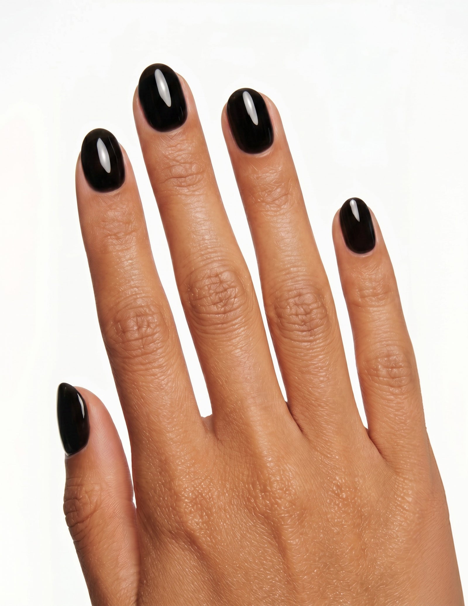 Blackout press-on nails — Oval (extra-short), tan hand, back of hand