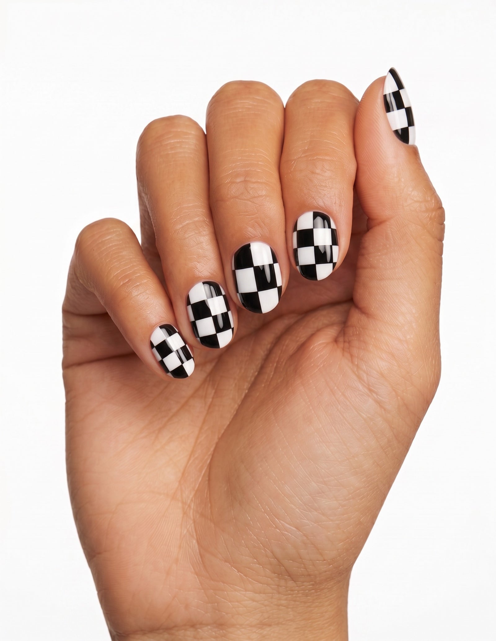 Checkmate press-on nails — Oval (extra-short), tan hand, fingers curled
