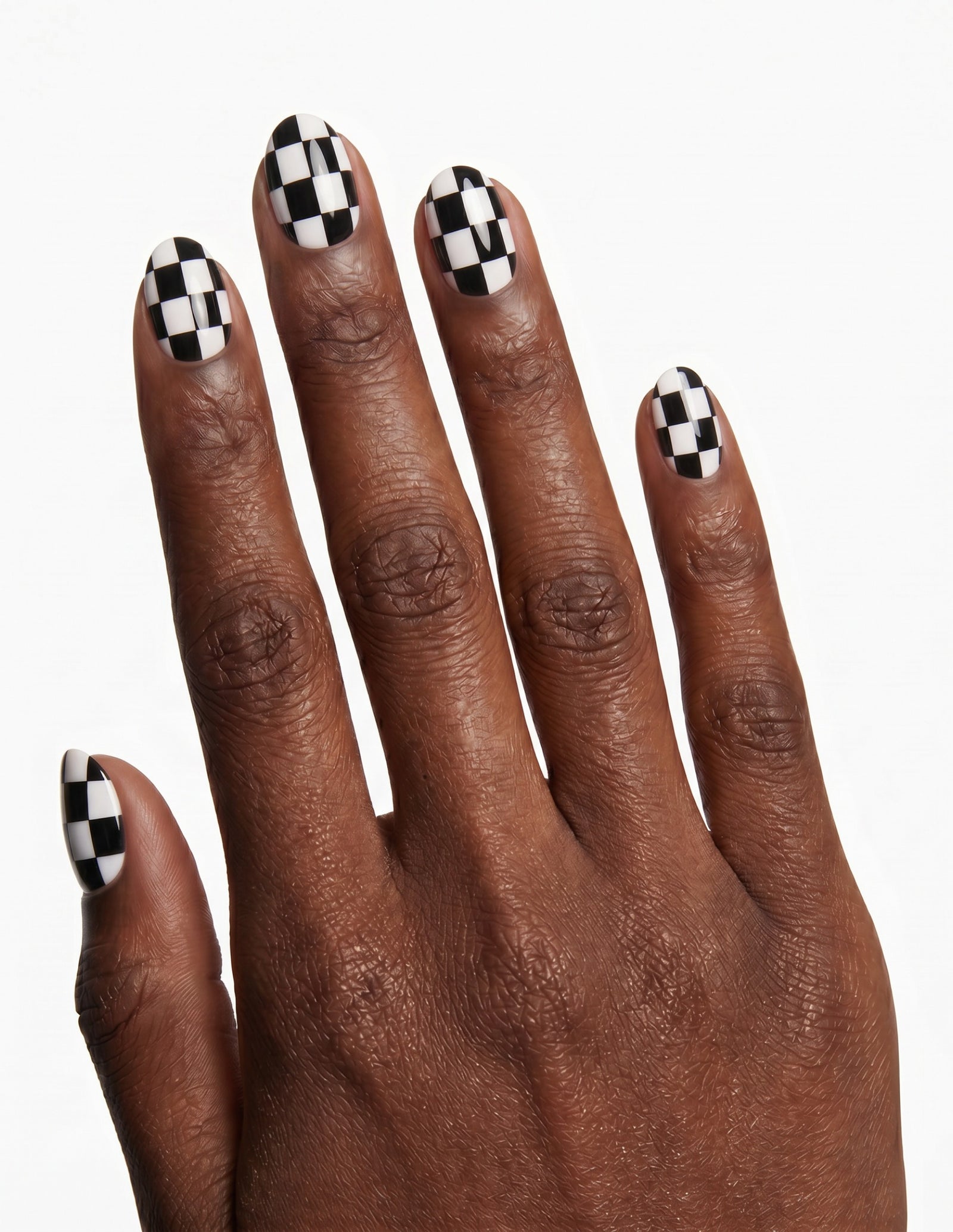 Checkmate press-on nails — Oval (extra-short), deep-skin hand, back of hand