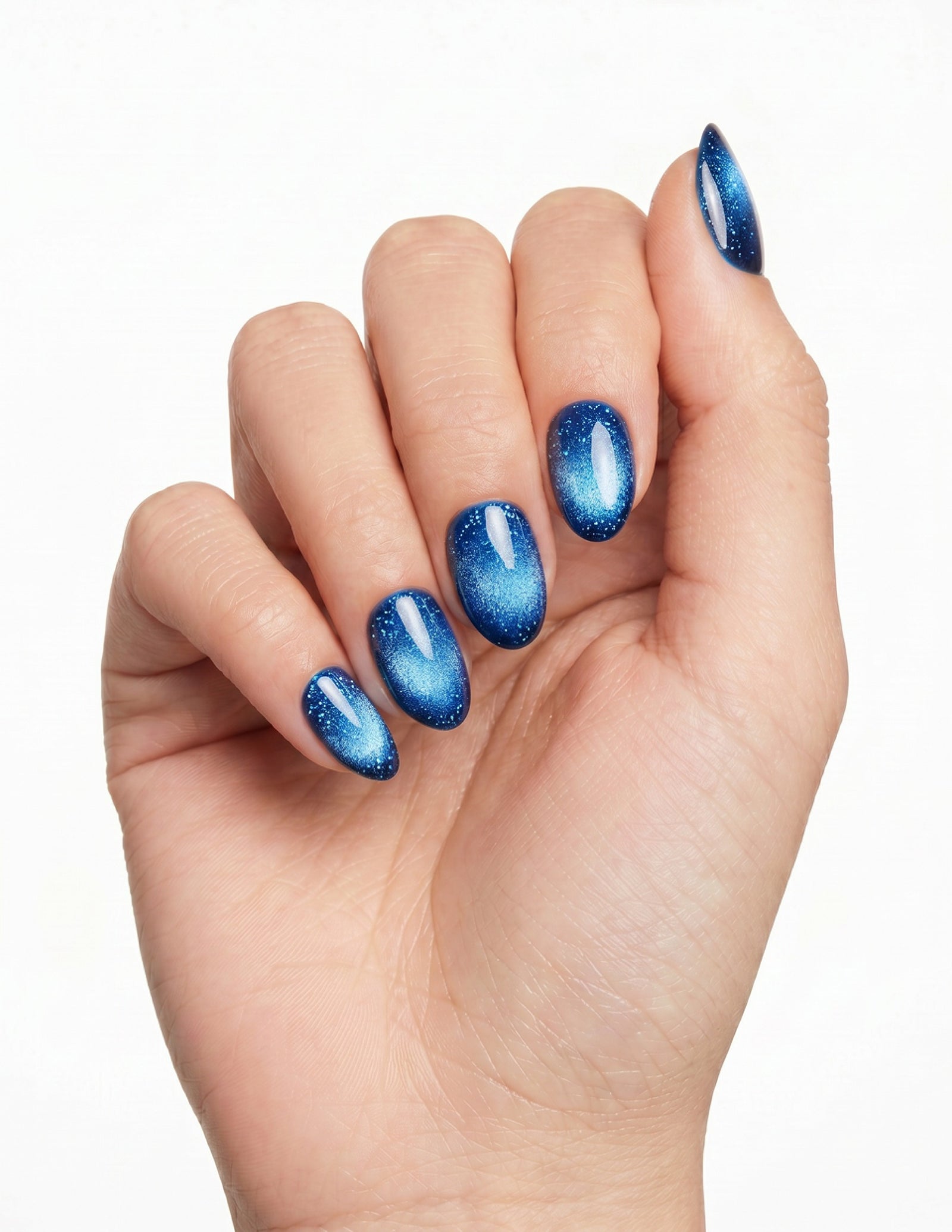 Cobalt press-on nails — Almond (extra-short), light-skin hand, fingers curled
