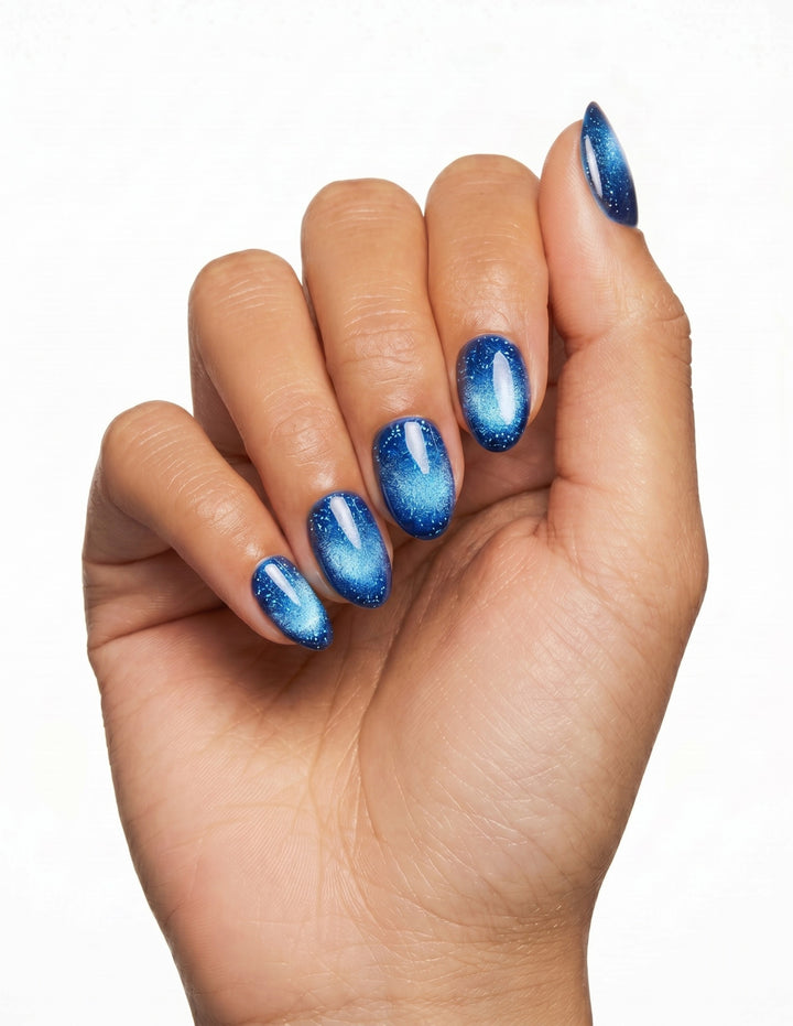 Cobalt press-on nails — Almond (extra-short), tan hand, fingers curled