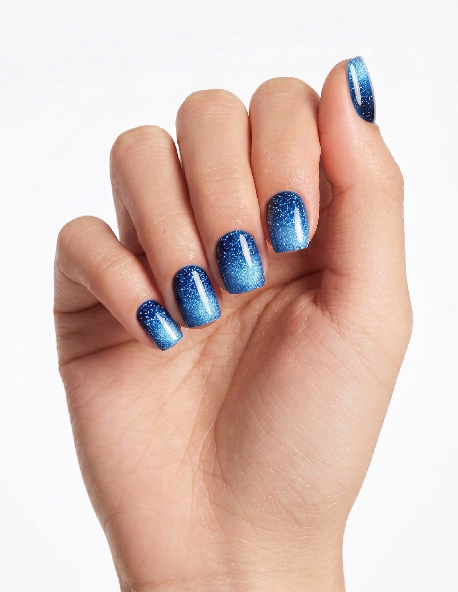 Cobalt press-on nails — Coffin (short), light-skin hand, fingers curled