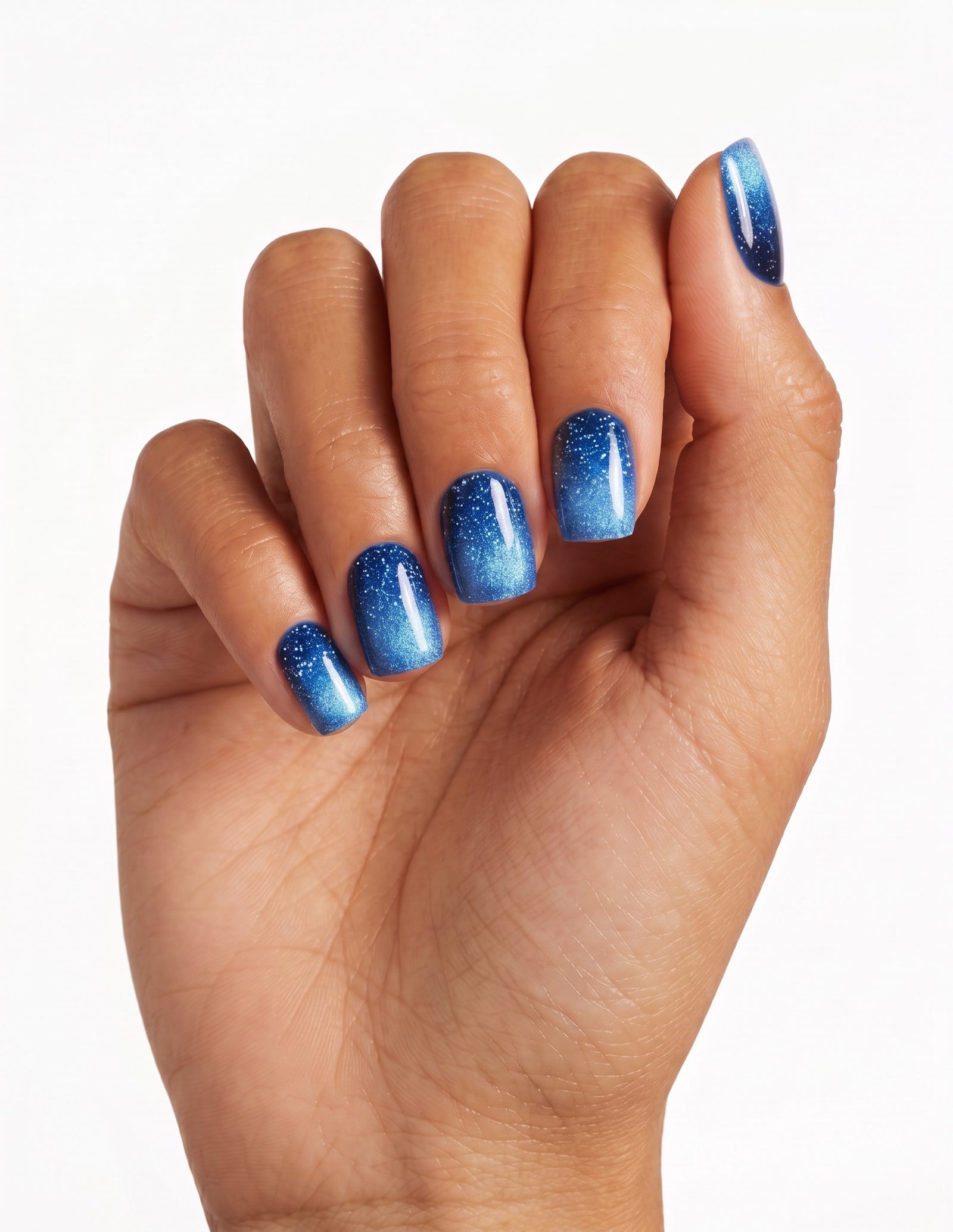 Cobalt press-on nails — Coffin (short), tan hand, fingers curled