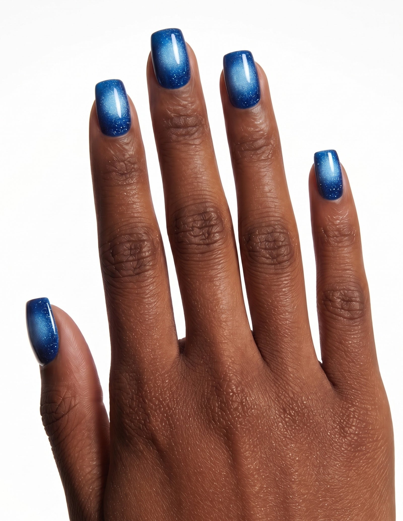Cobalt press-on nails — Coffin (short), deep-skin hand, back of hand